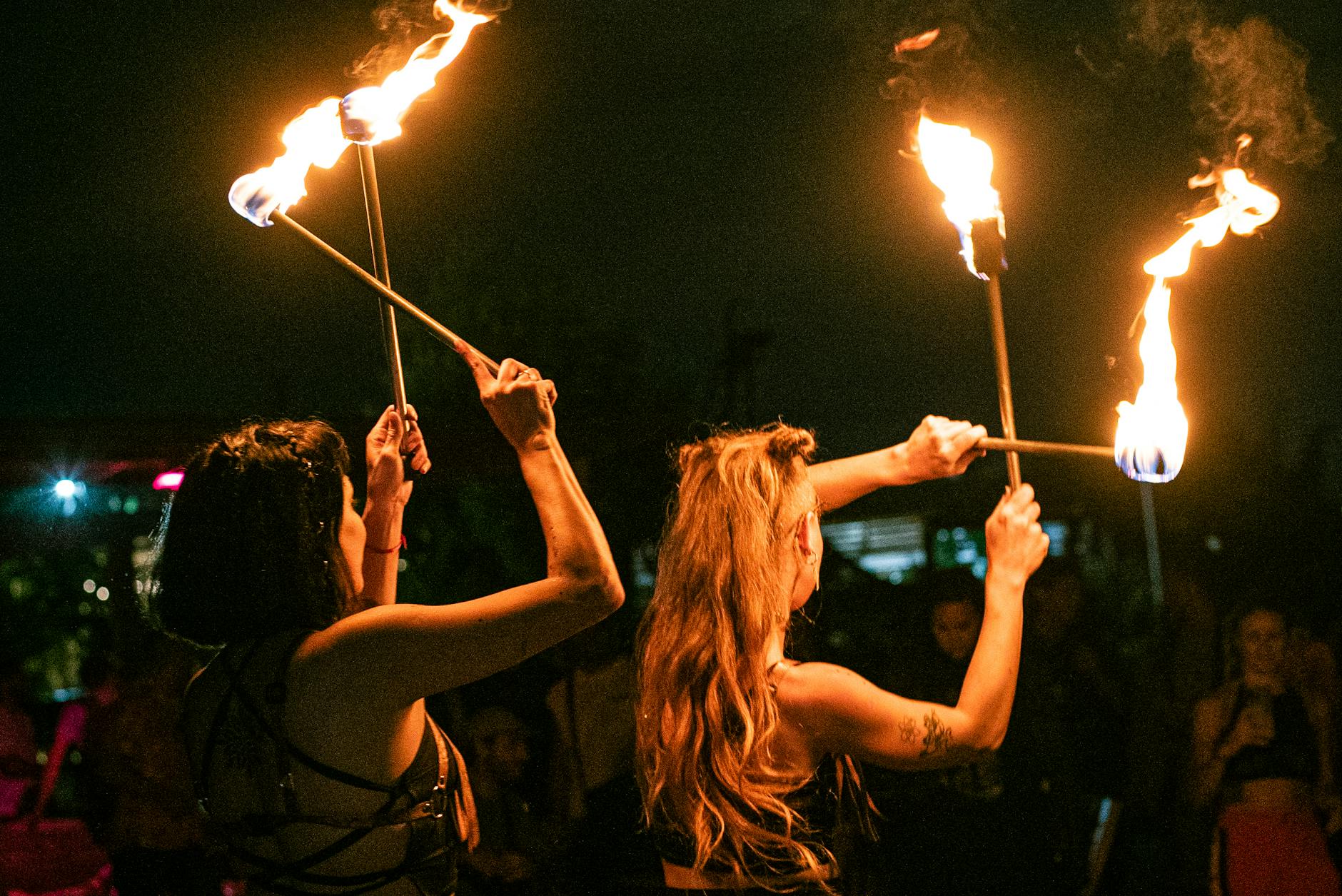 women with flames in the dark