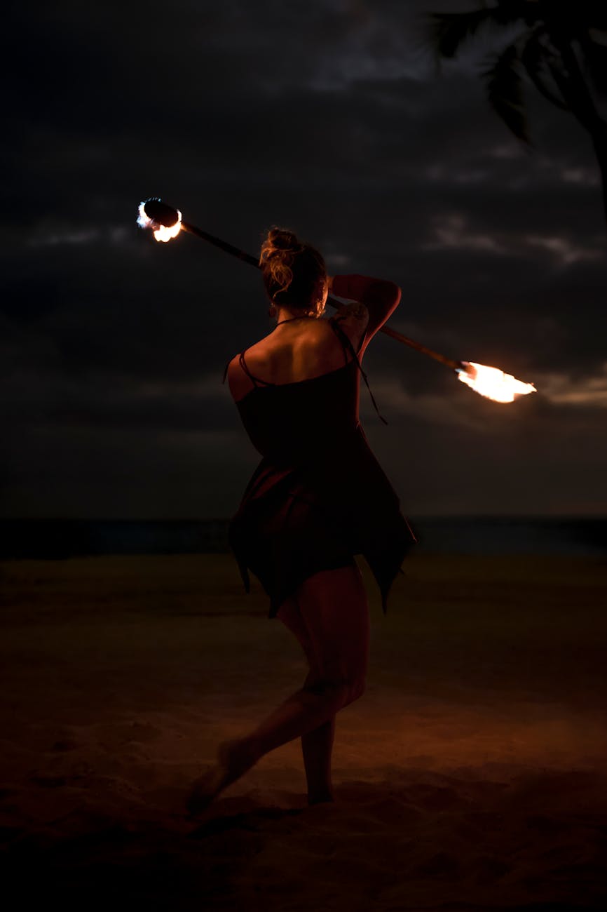 woman in performance with fire poi stick at night on beach 4 Unusual Hobbies That Break Free From The Mold