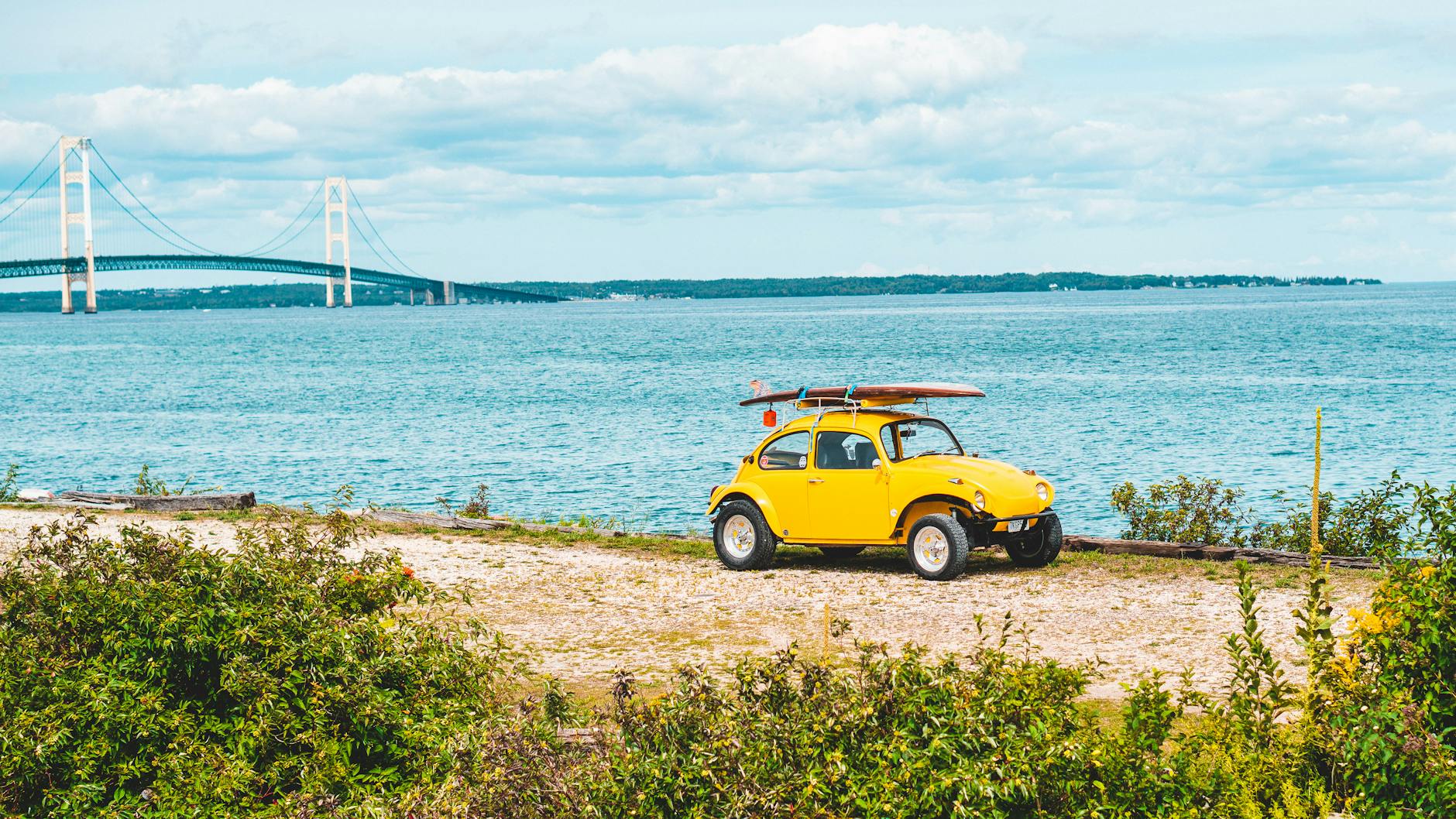 yellow volkswagen beetle on a seaside Moving to Michigan: Migration Trends and Top Destinations