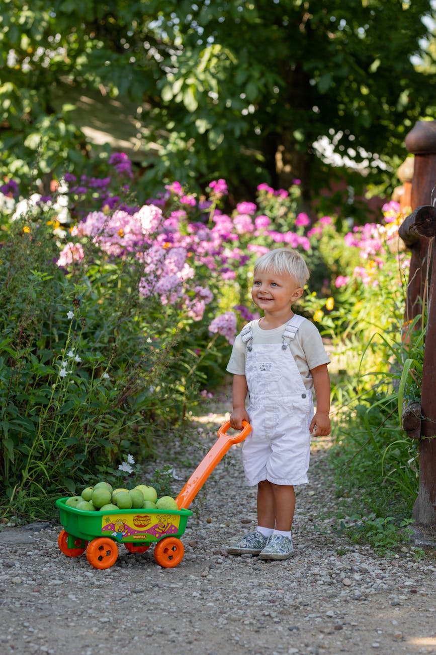 toddler enjoys summer day in a lush garden How to Make Your Garden Fun and Kid-Friendly