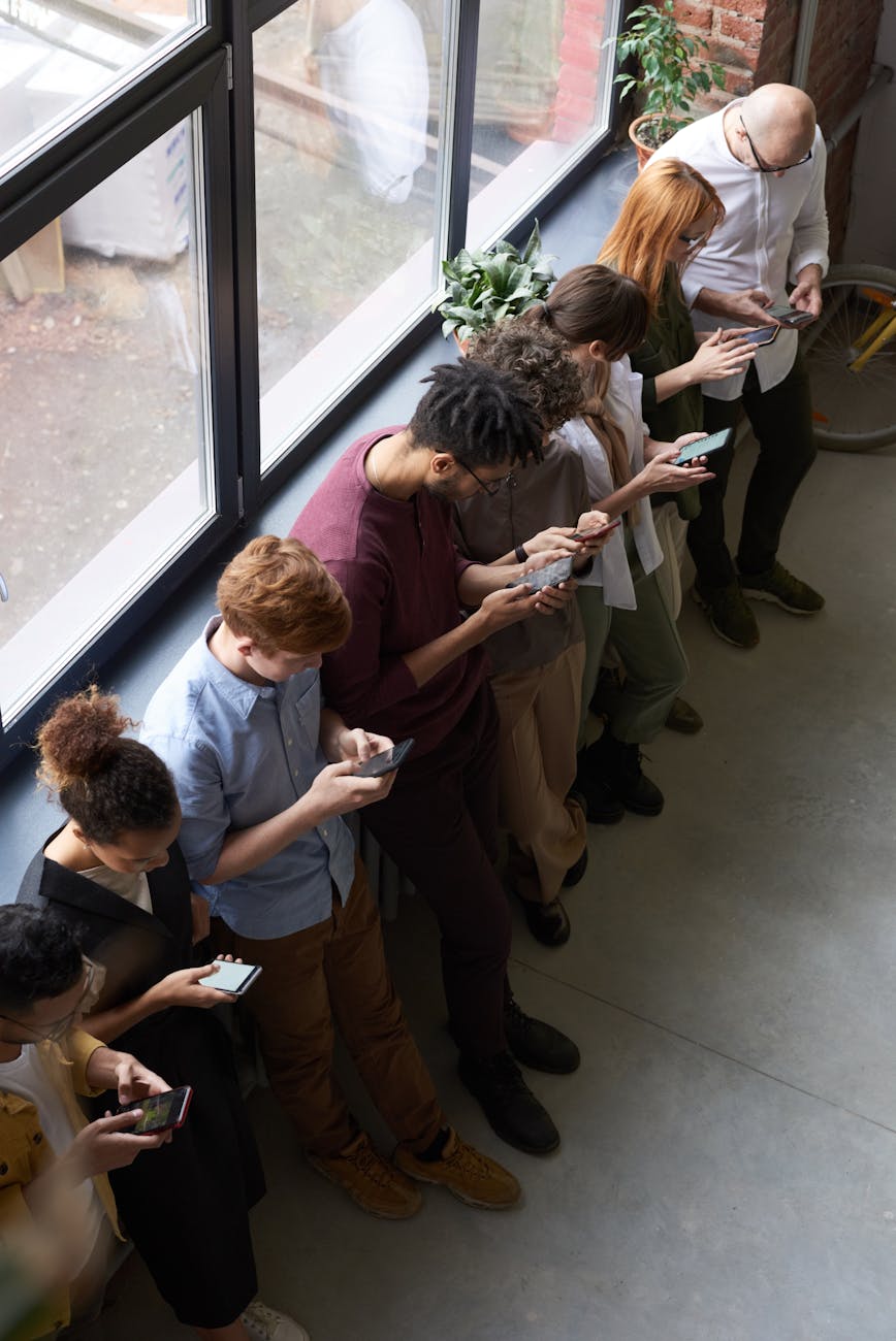 people holding their phones How Business Communication Technology Is Revolutionizing the Way We Work