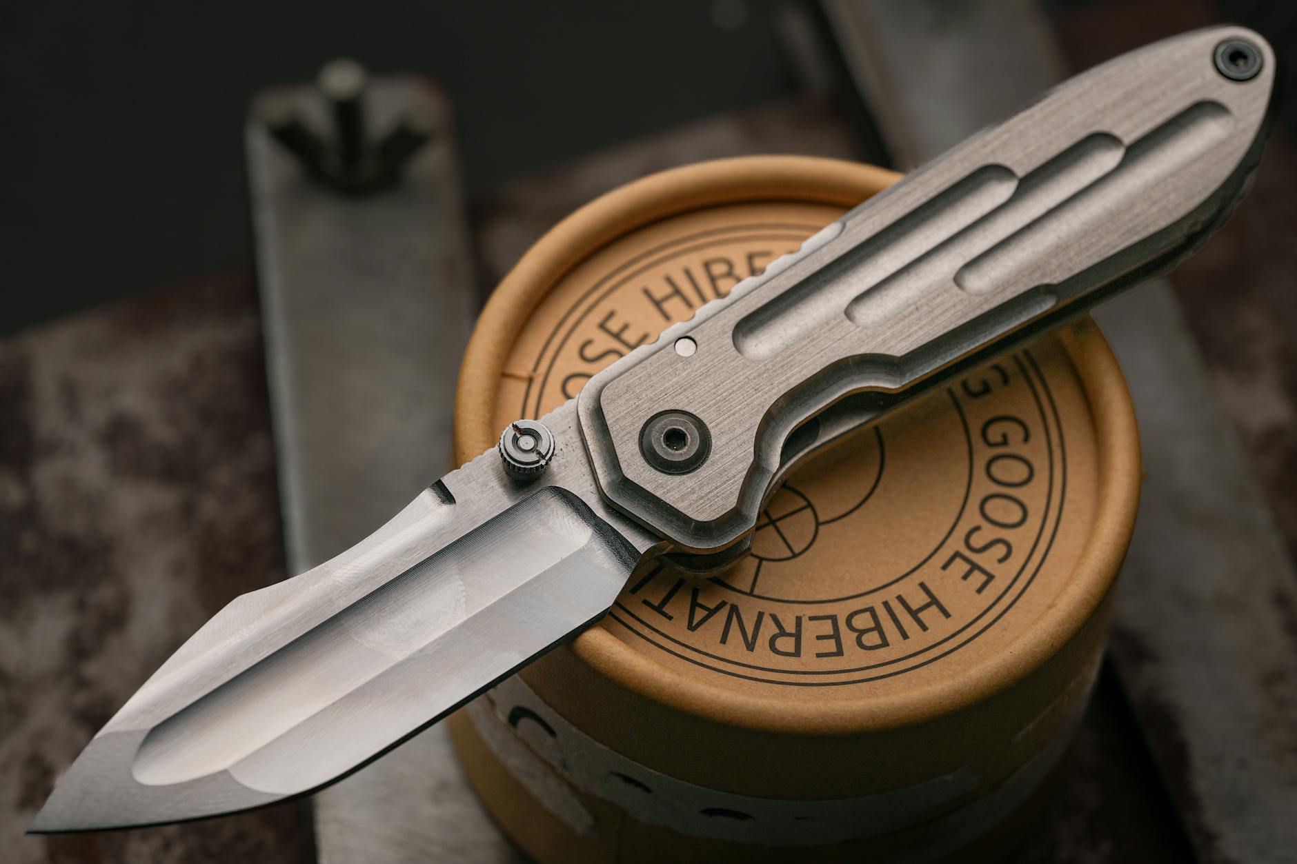 sleek titanium folding knife on round box Why Packaging Design Is Part of Customer Service Levels (And How to Get It Right)