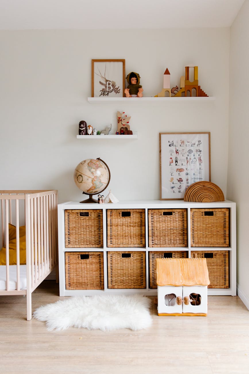 interior of children bedroom with wooden furniture and toys and globe placed on shelves in room How to Create a Kid-Friendly Home Without Sacrificing Style