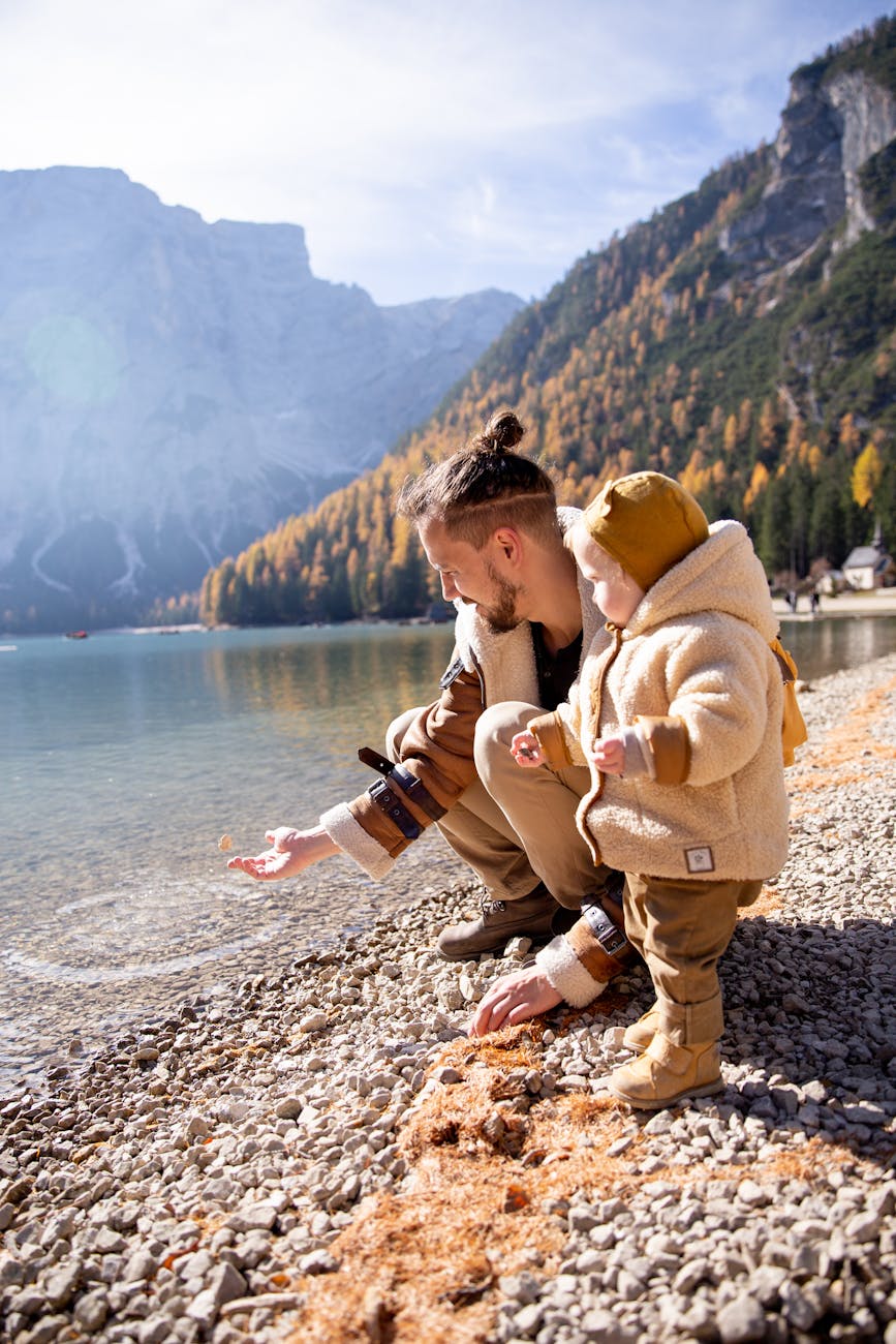 7 Fun Family Vacation Ideas Your Kids Will Love 14 man in brown coat sitting on rocky shore 7 Fun Family Vacation Ideas Your Kids Will Love