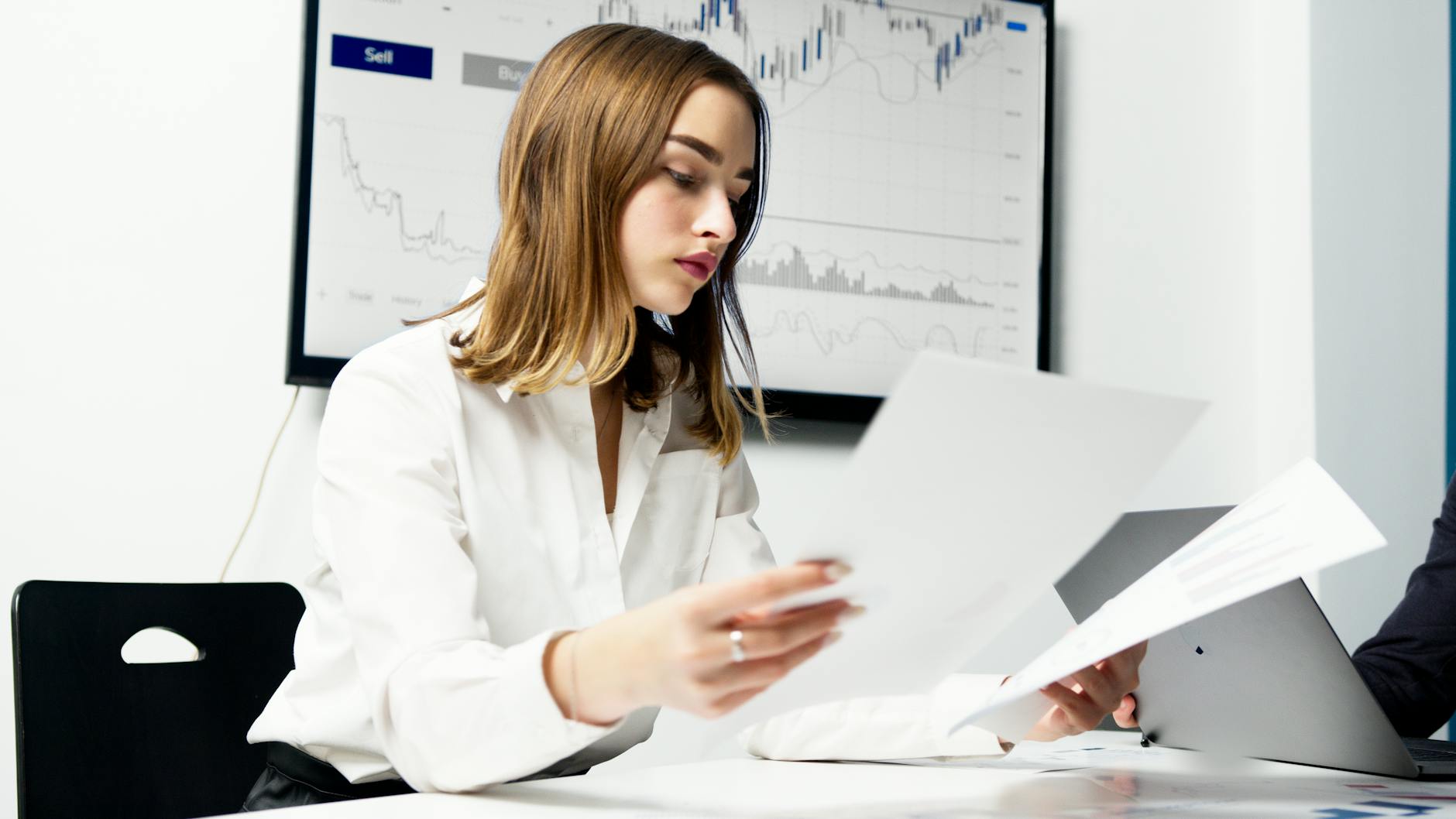 a woman in white dress shirt holding pieces of paper How to Overcome Business Challenges and Get Back on Track