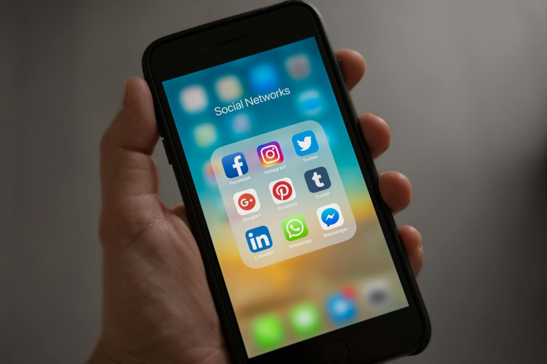 5 Essential Strategies to Build Brand Visibility Long-Term 9 person holding iphone showing social networks folder 5 Essential Strategies to Build Brand Visibility Long-Term