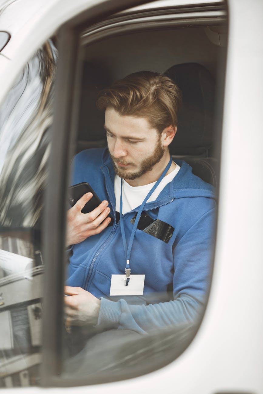 deliveryman sitting in car What Businesses Need to Know About Driver Safety Compliance