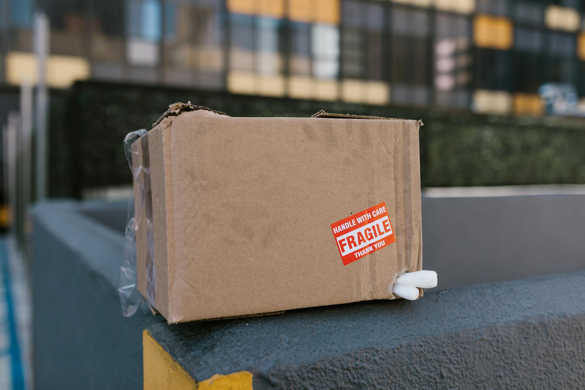 cardboard box on top of a concrete fence Why Packaging Design Is Part of Customer Service Levels (And How to Get It Right)