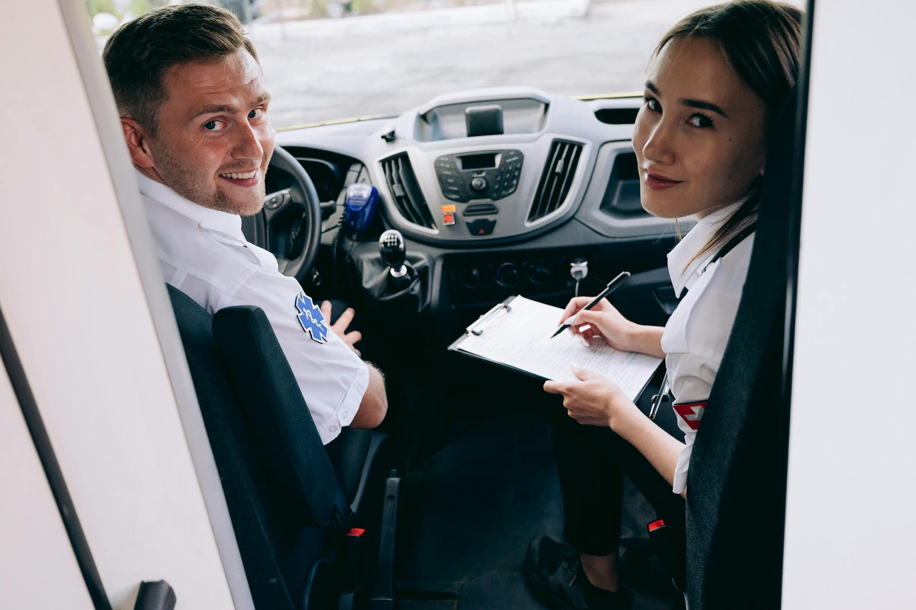 a man and woman sitting inside the car