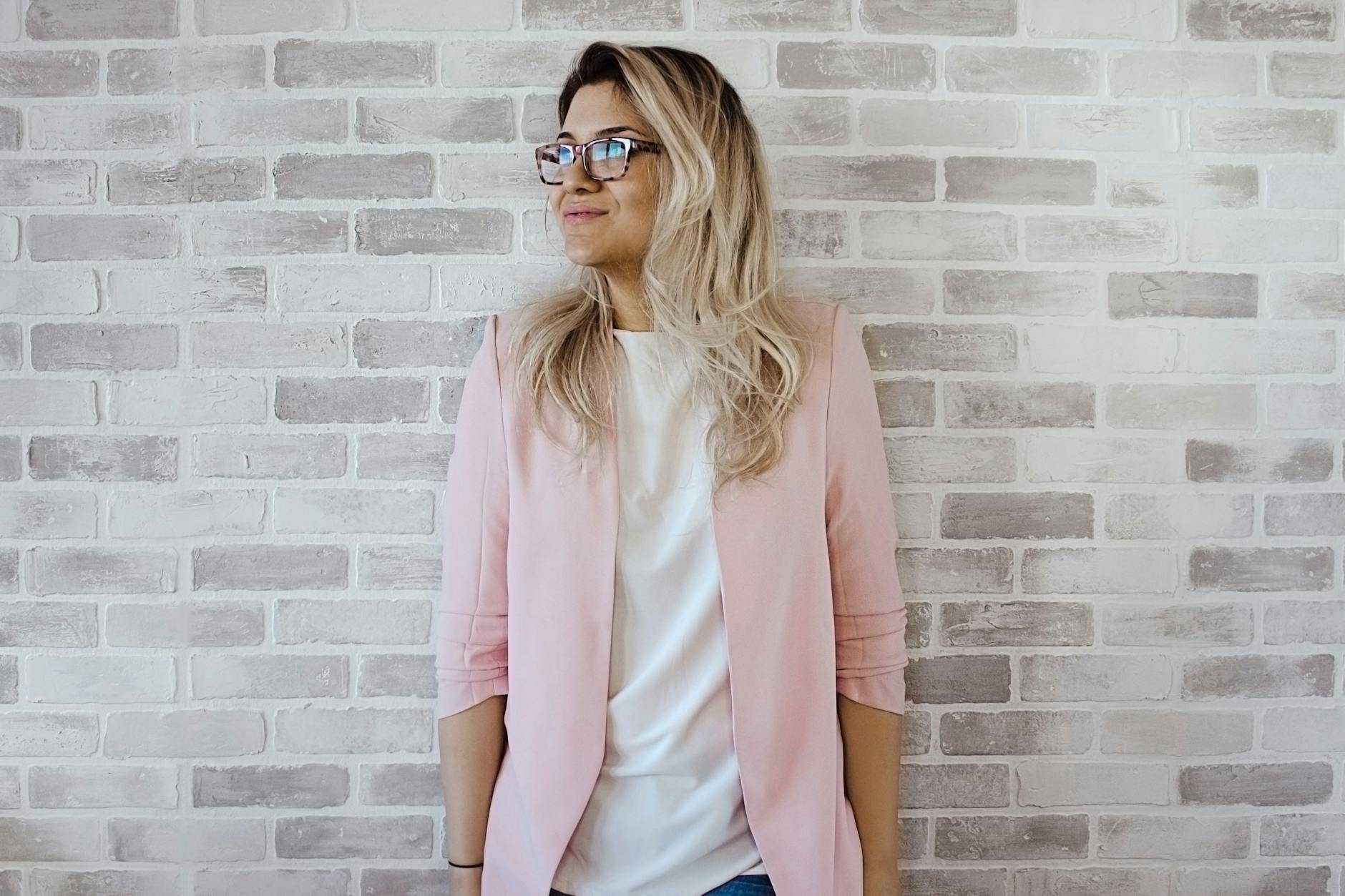Planning a Career Change: Key Steps for a Smooth Transition 7 woman in pink cardigan and white shirt leaning on the wall Planning a Career Change: Key Steps for a Smooth Transition