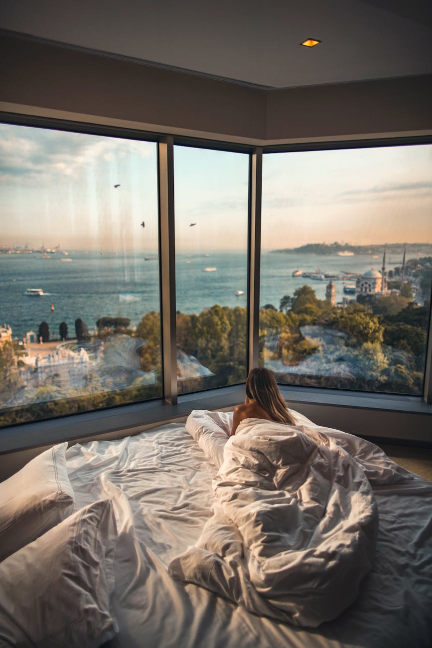 Elevate Your Escape: Plan a Luxury Travel Experience 9 woman laying down on bed inside room Elevate Your Escape: Plan a Luxury Travel Experience