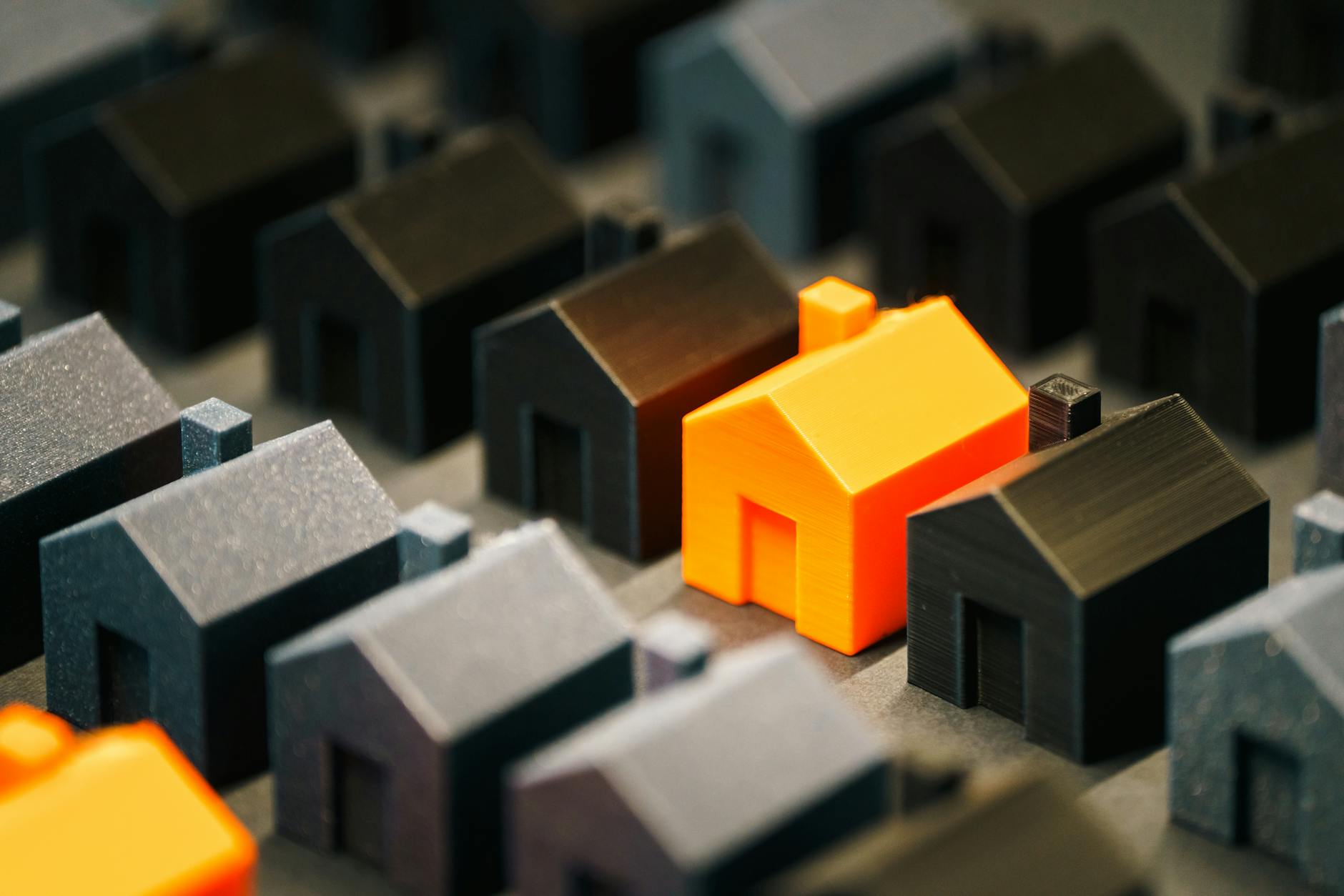 orange model house among black miniatures What To Do When Inheriting A Large Sum Of Money