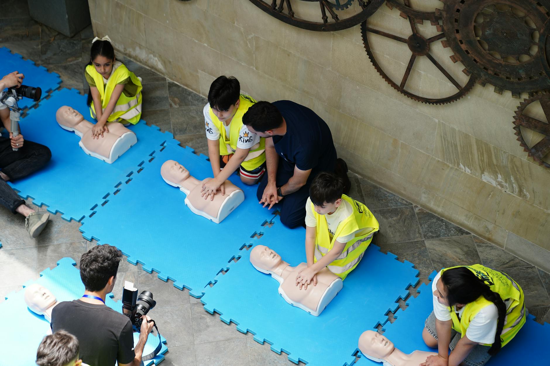 cpr training workshop with mannequins in baku 12 Essential Life Skills to Teach Your Kids (Beyond School Lessons)