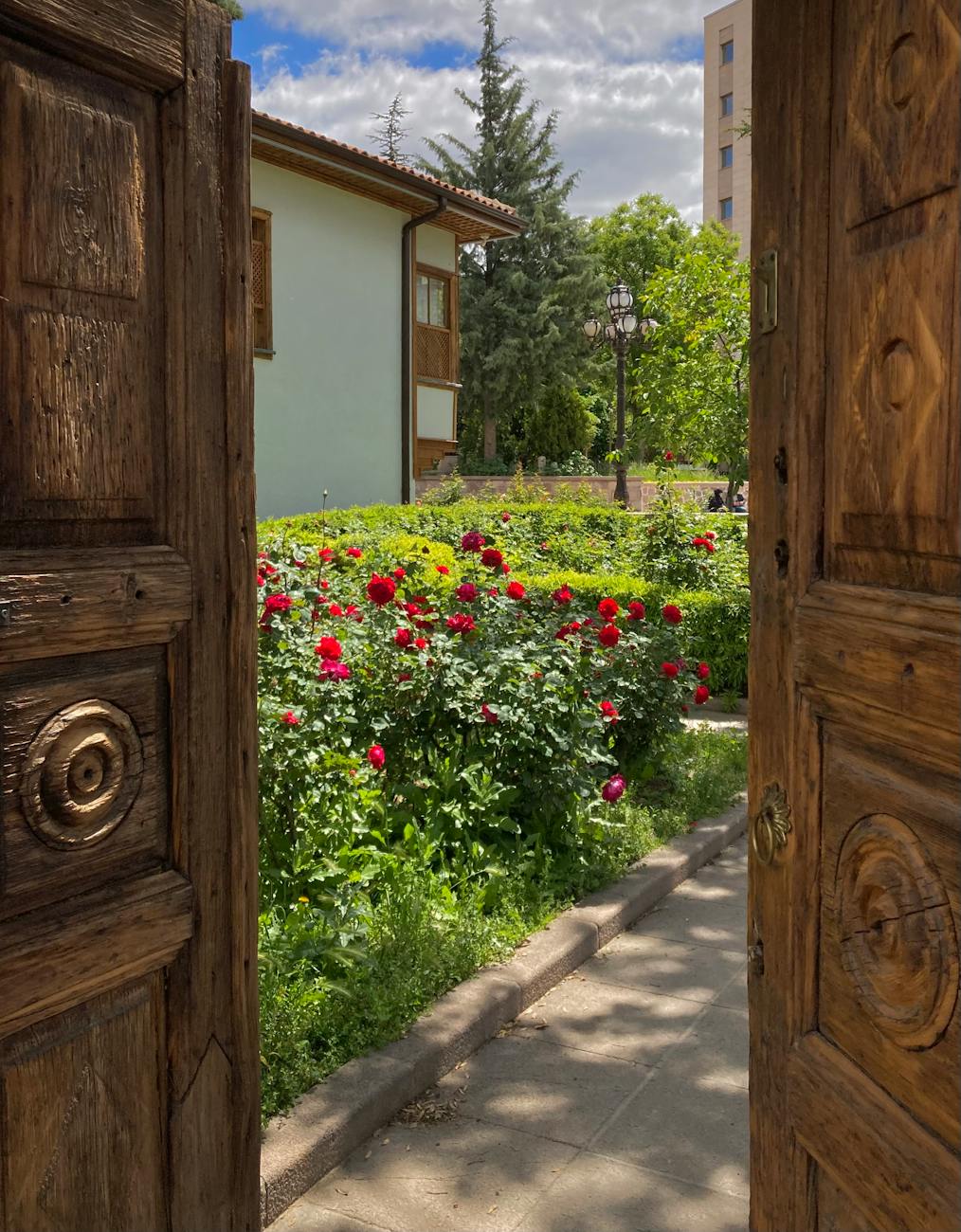 The Ultimate List of Gardening Skills 15 charming garden view through rustic wooden door The Ultimate List of Gardening Skills