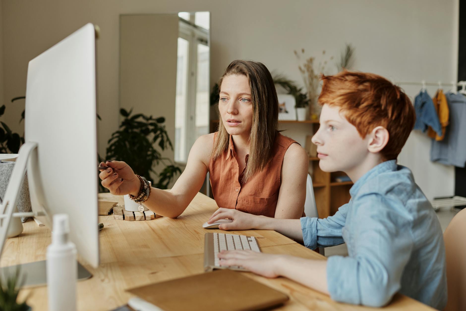 photo of woman tutoring young boy 12 Essential Life Skills to Teach Your Kids (Beyond School Lessons)