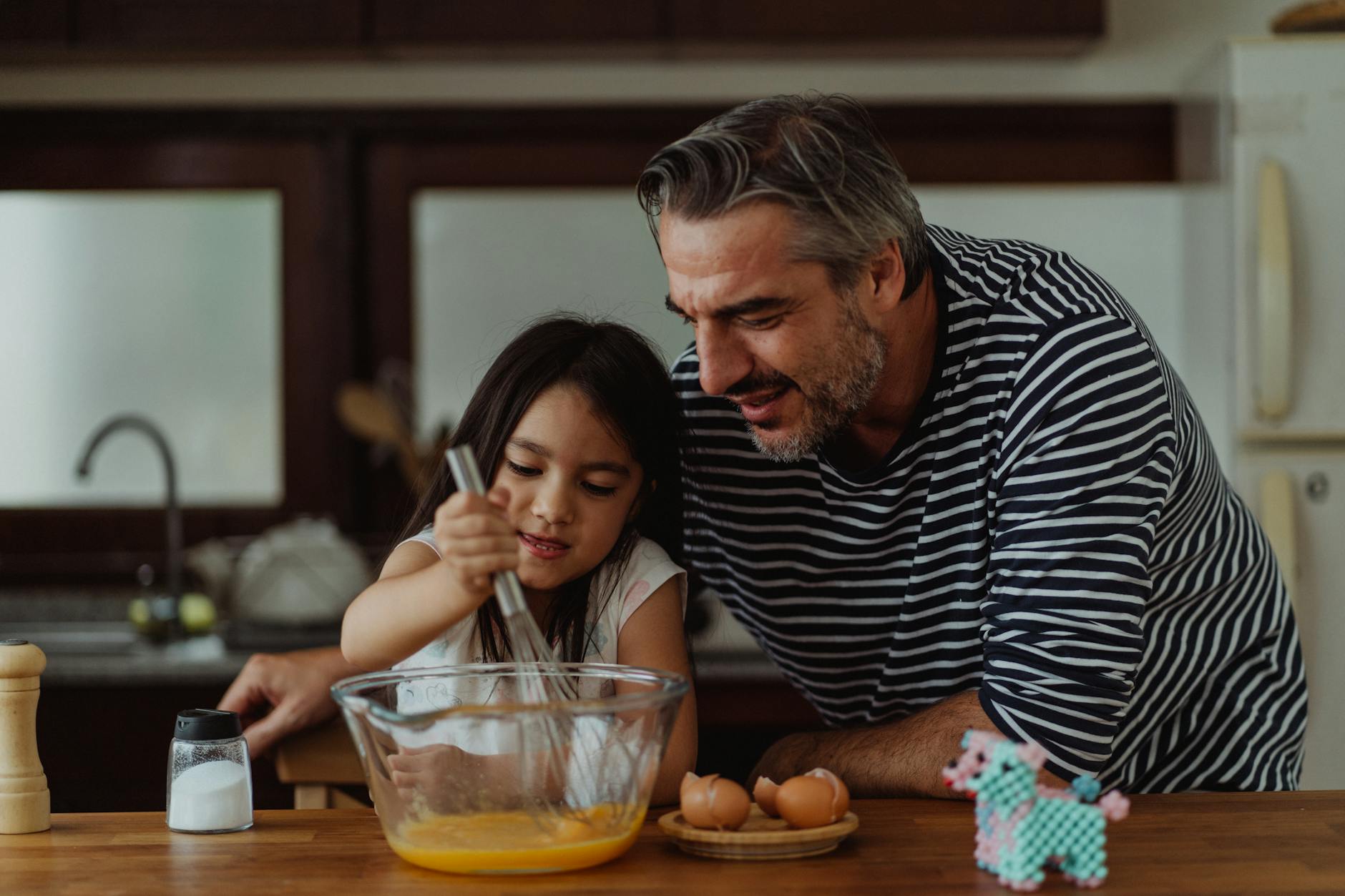 father and daughter cooking together