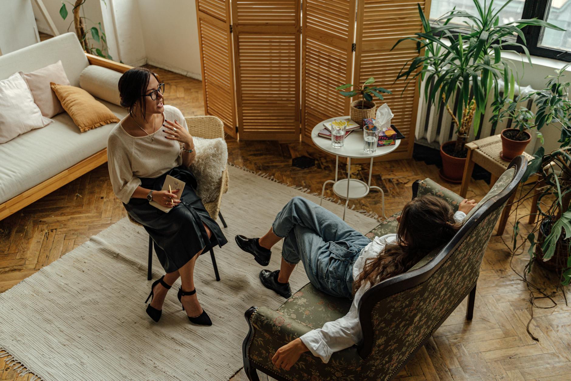 woman in white long sleeve shirt sitting on brown wooden armchair Before Offering Mental Health Perks, Fix These Workplace Issues