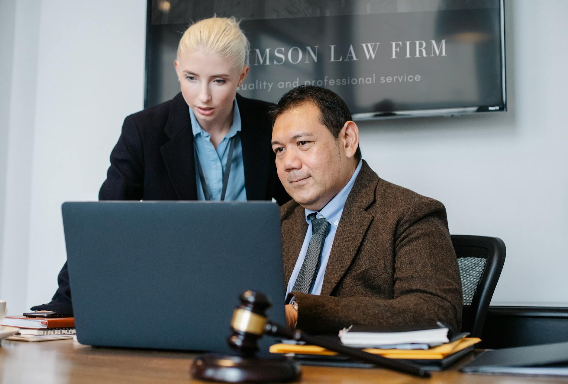 diverse lawyers looking at laptop Law Firm Brand Identity: Positioning Your Practice to Attract Ideal Clients