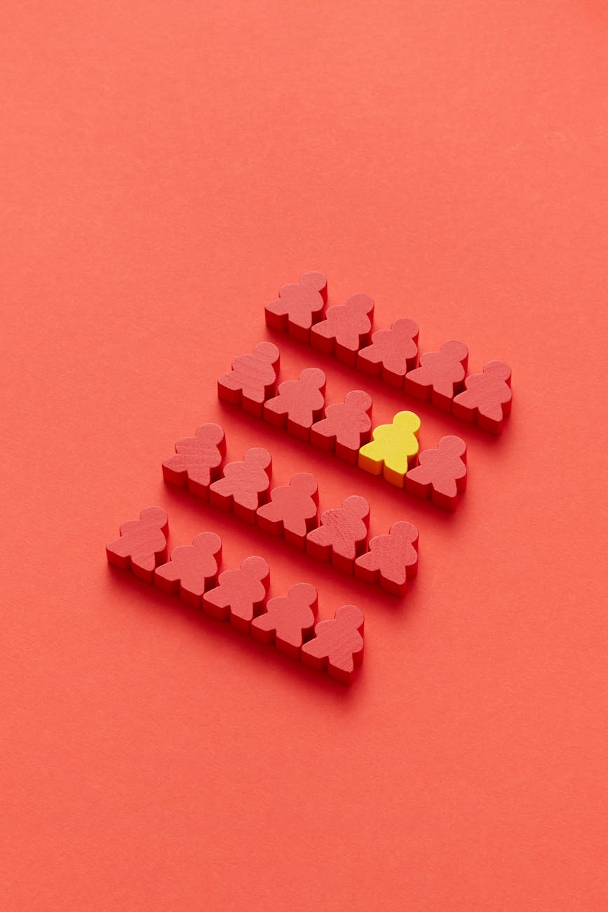 photo of a yellow meeple between red meeple pieces How to Make Your Small Business Stand Out In a Crowded Marketplace