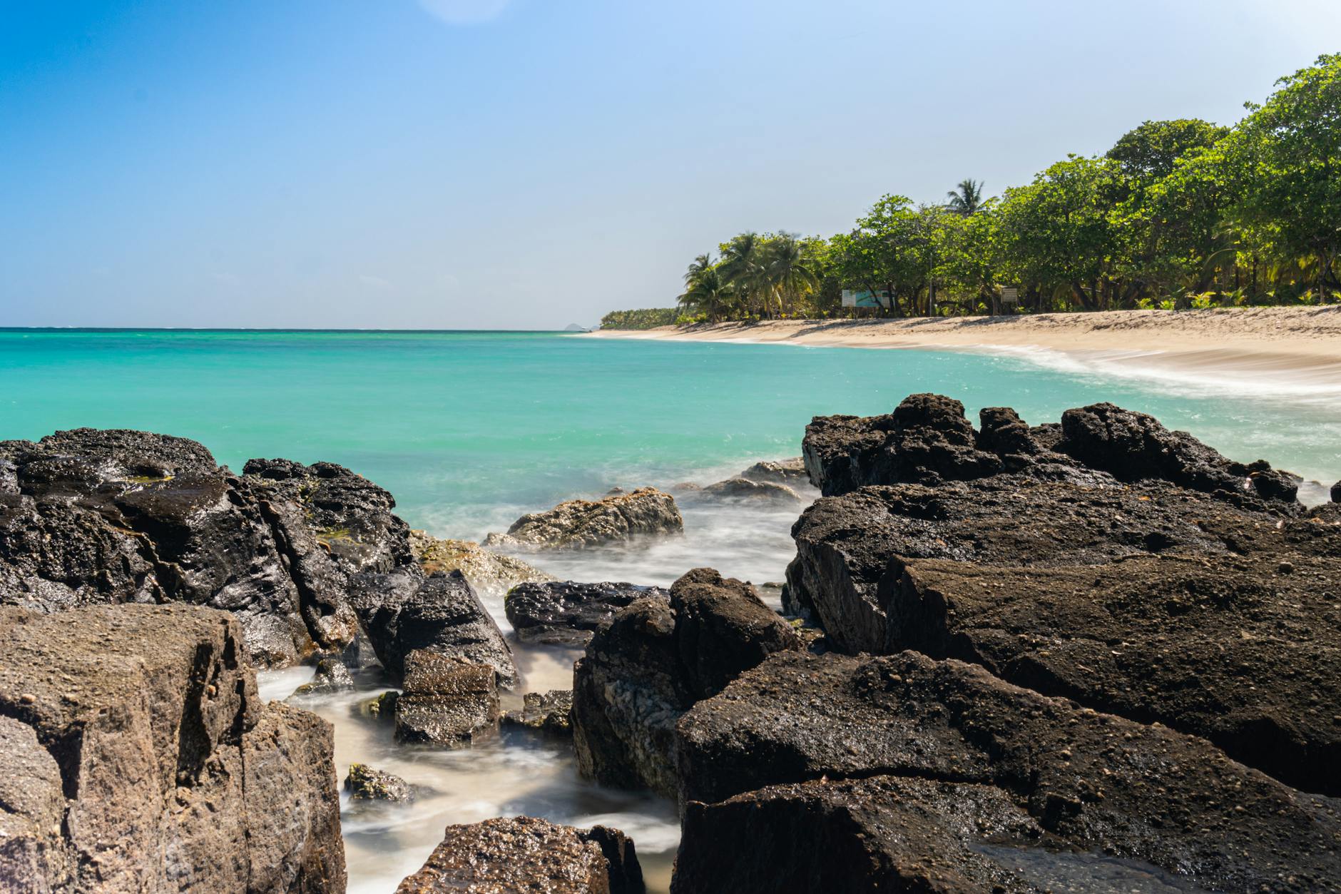 Why Honduras Property Investment Is a Smart Choice for Your Real Estate Portfolio 17 beach with blue water and a rocky shore Why Honduras Property Investment Is a Smart Choice for Your Real Estate Portfolio