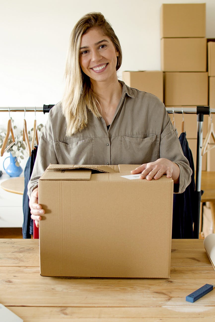 woman smiling while holding the package Why Streamlining Sales Orders Improves Customer Trust