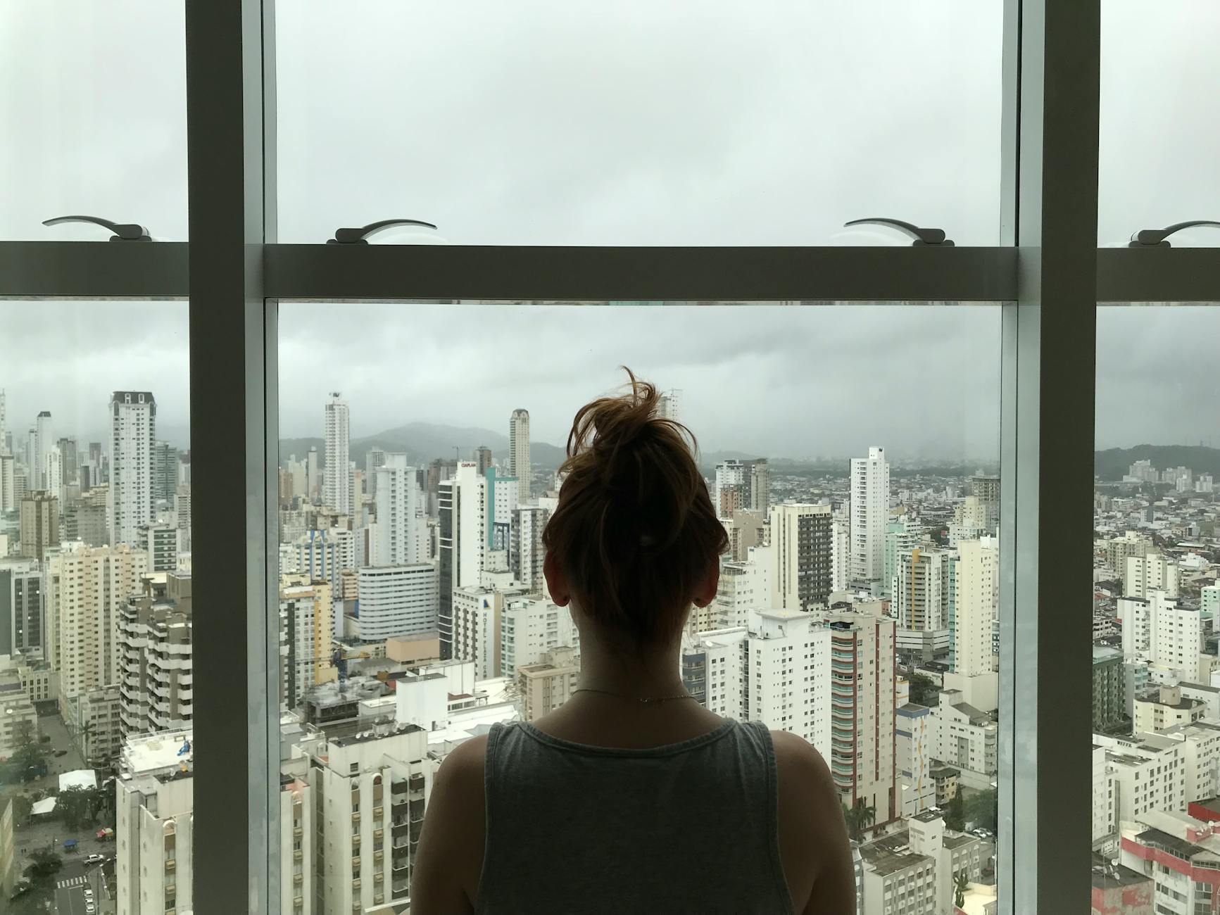 woman standing near glass window Top Tips for Finding the Perfect Place to Live