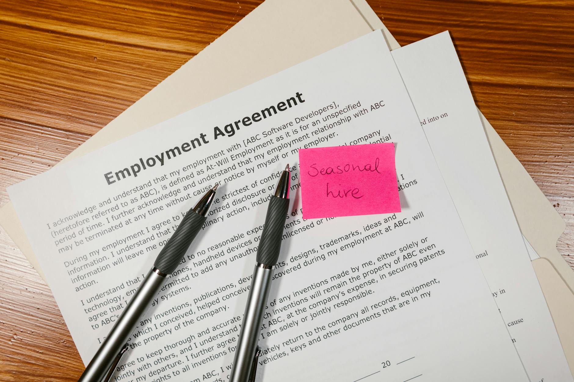 employment agreement paper with pen Employee Online Policy: How to Create Clear Rules Your Team Will Actually Follow