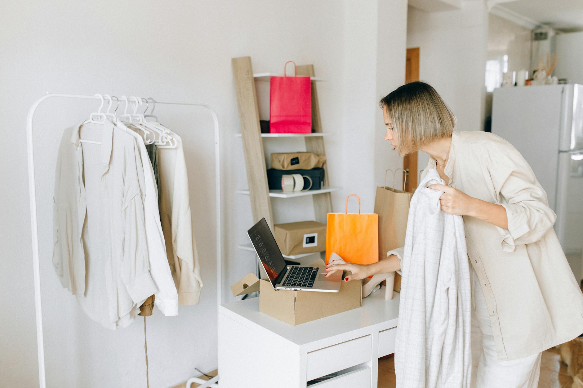 woman in white dress standing in front of white wooden desk Why Streamlining Sales Orders Improves Customer Trust