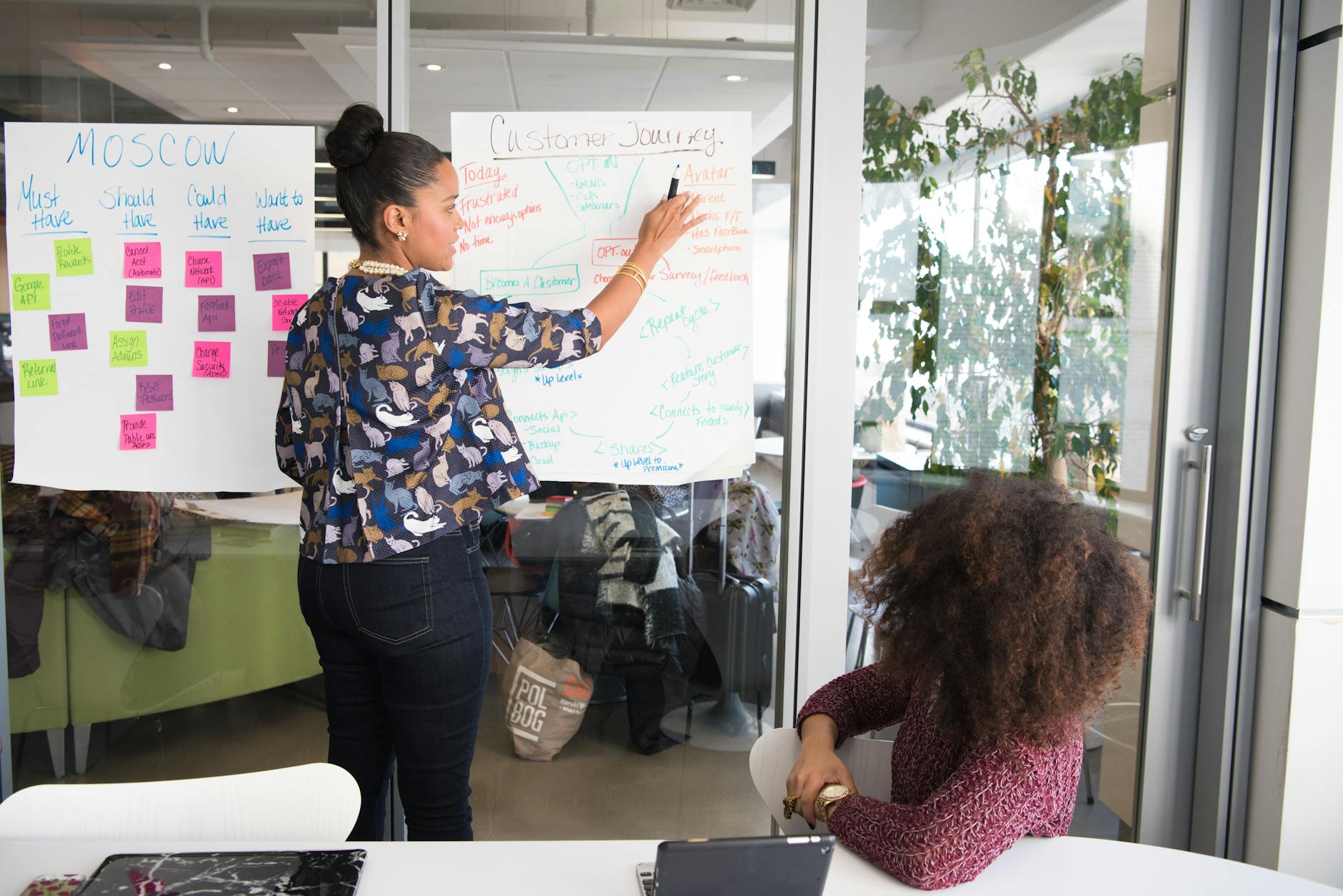 two women having a meeting inside glass panel office 10 Time-Saving Tricks to Improve Customer Service