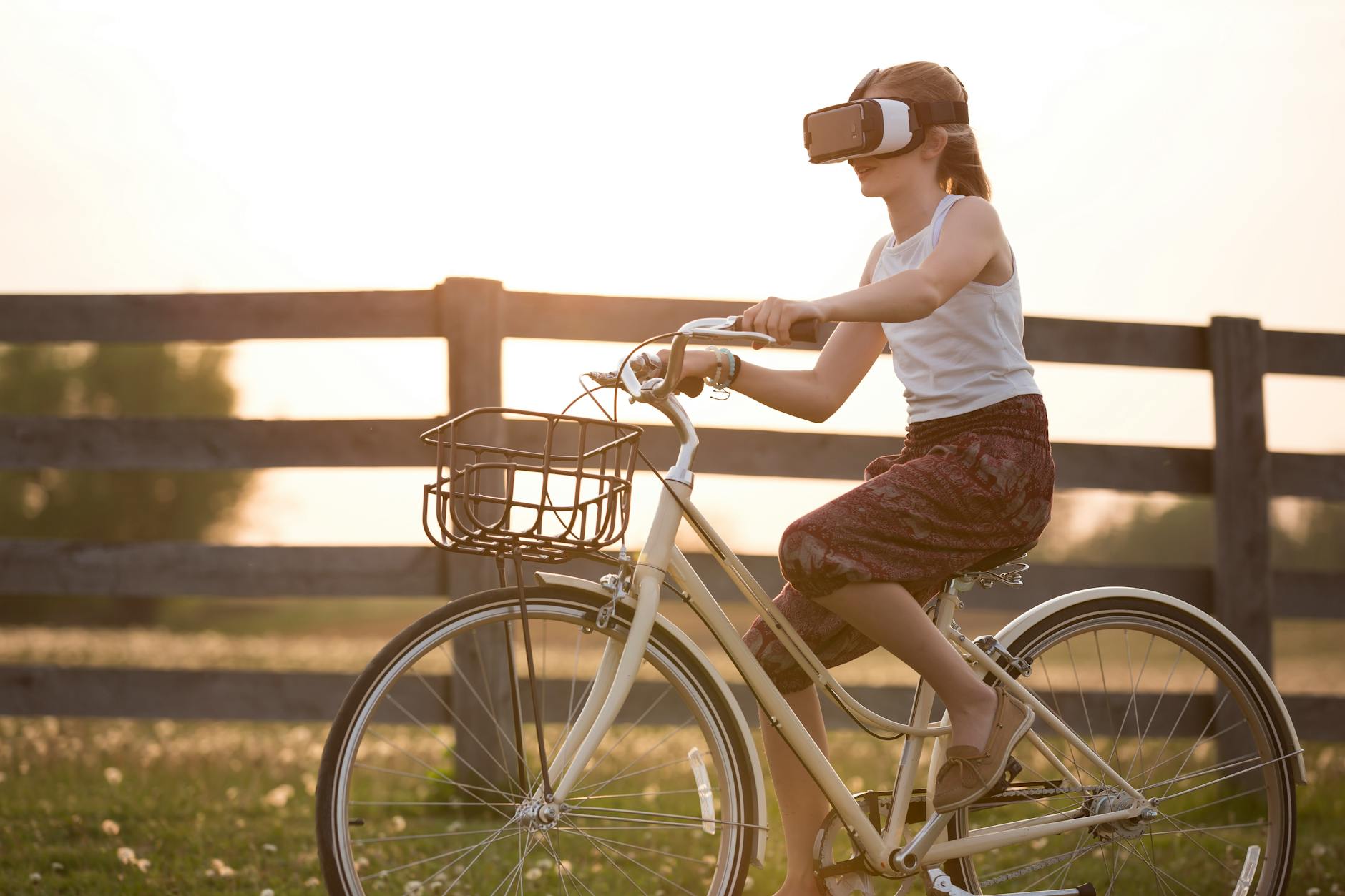 girl wearing vr box driving bicycle during golden hour Rural Tech Tools That Make Country Living Easier