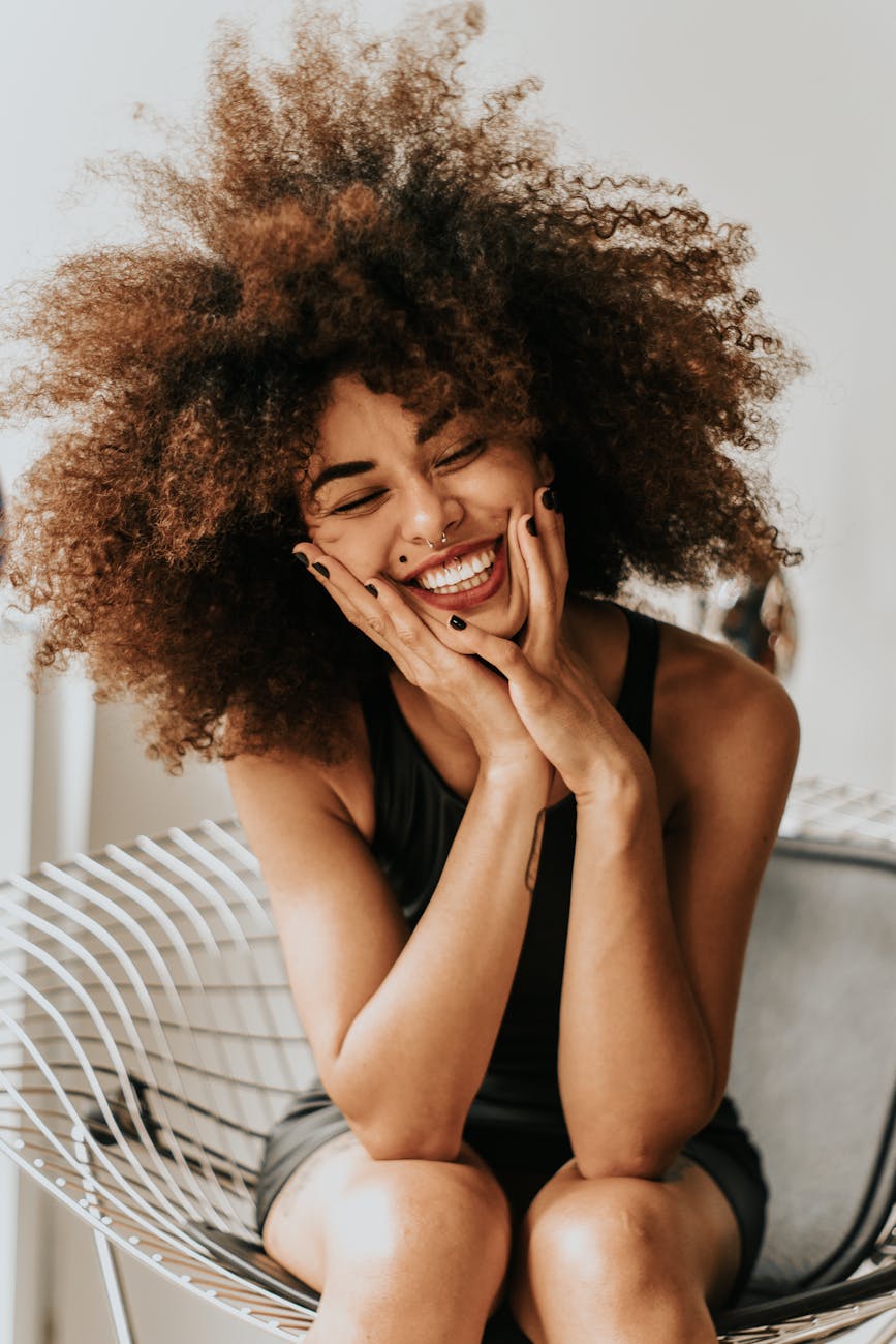 woman sitting and smiling Rediscover Yourself: 10 Gentle Ways to Reconnect with Who You Are