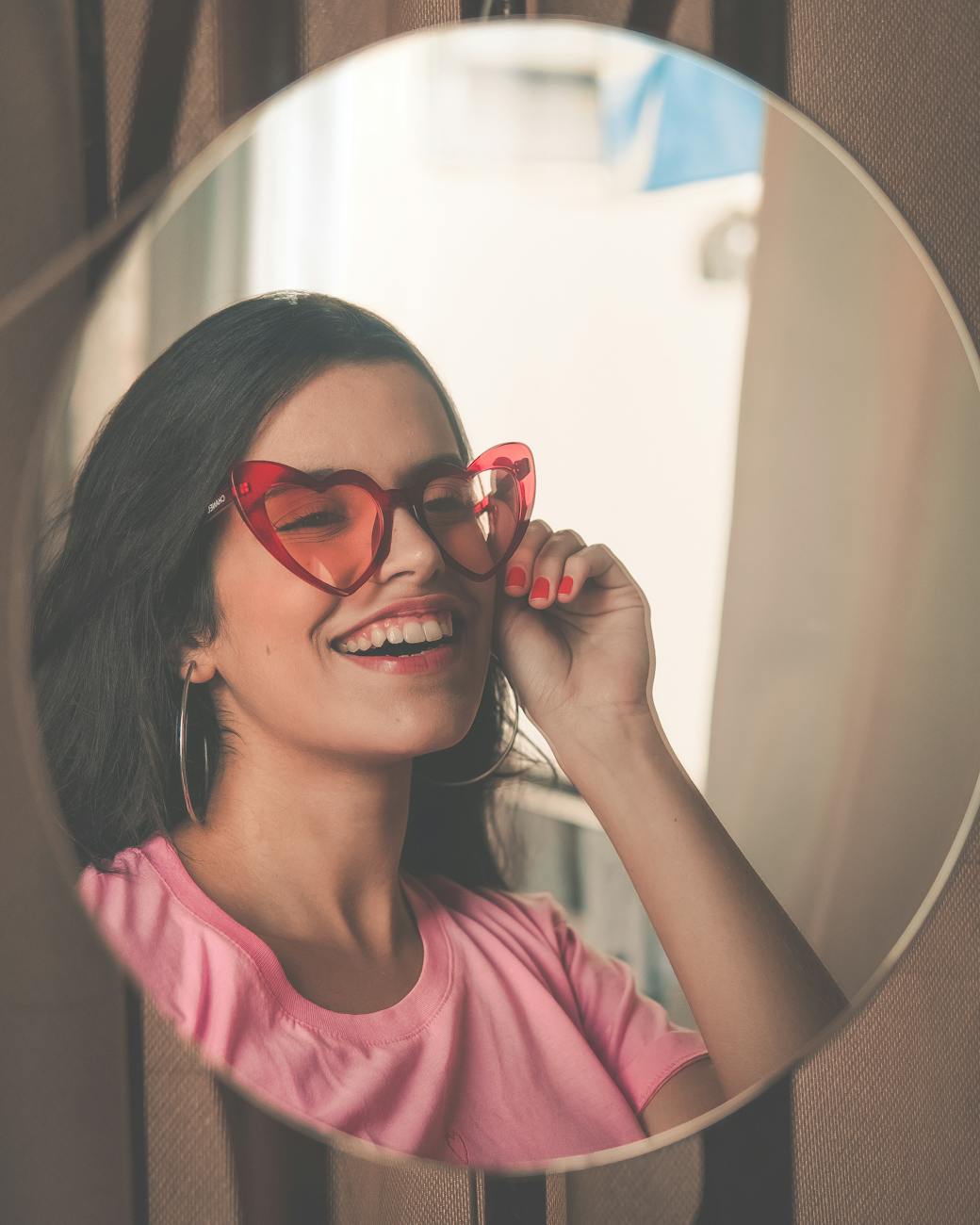 smiling woman wearing red sunglasses Rediscover Yourself: 10 Gentle Ways to Reconnect with Who You Are