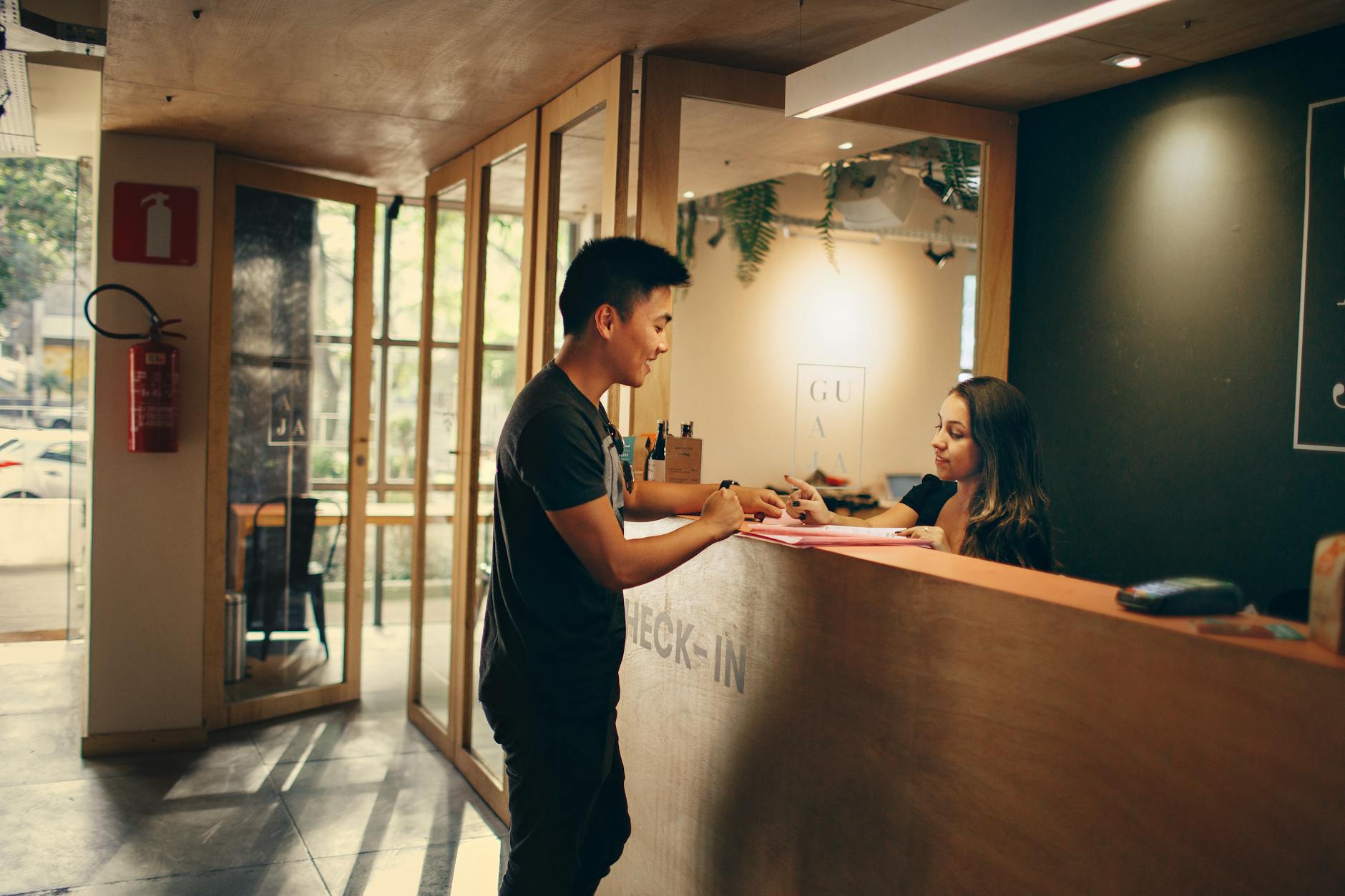 man standing in front of front desk How to Make Clients Feel Valued Before You Even Speak