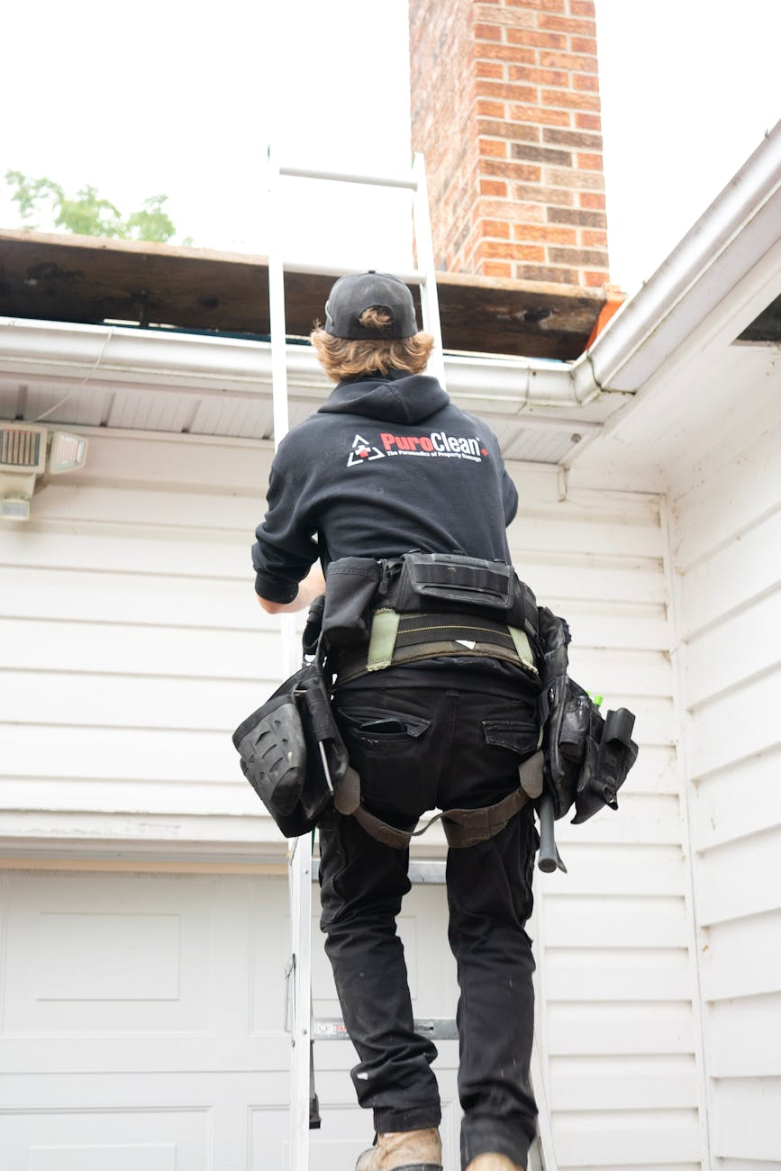 8 Things You’ll Regret Not Doing Before Moving Into Your New Home 10 professional roofer climbing ladder near chimney 8 Things You’ll Regret Not Doing Before Moving Into Your New Home