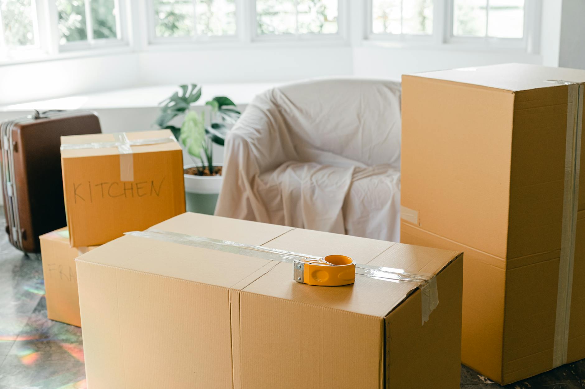 empty apartment with packed carton boxes before moving Beyond Moving Boxes: Extra Services Moving Companies Offer
