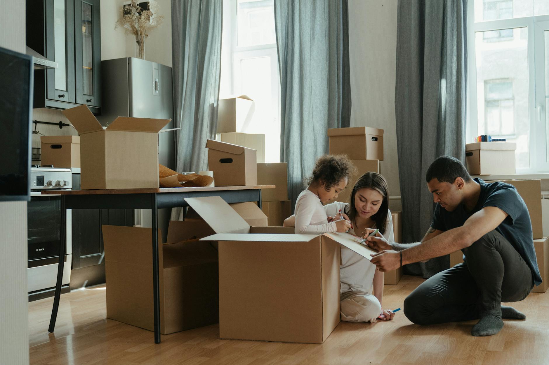 family unpacking after moving Beyond Moving Boxes: Extra Services Moving Companies Offer