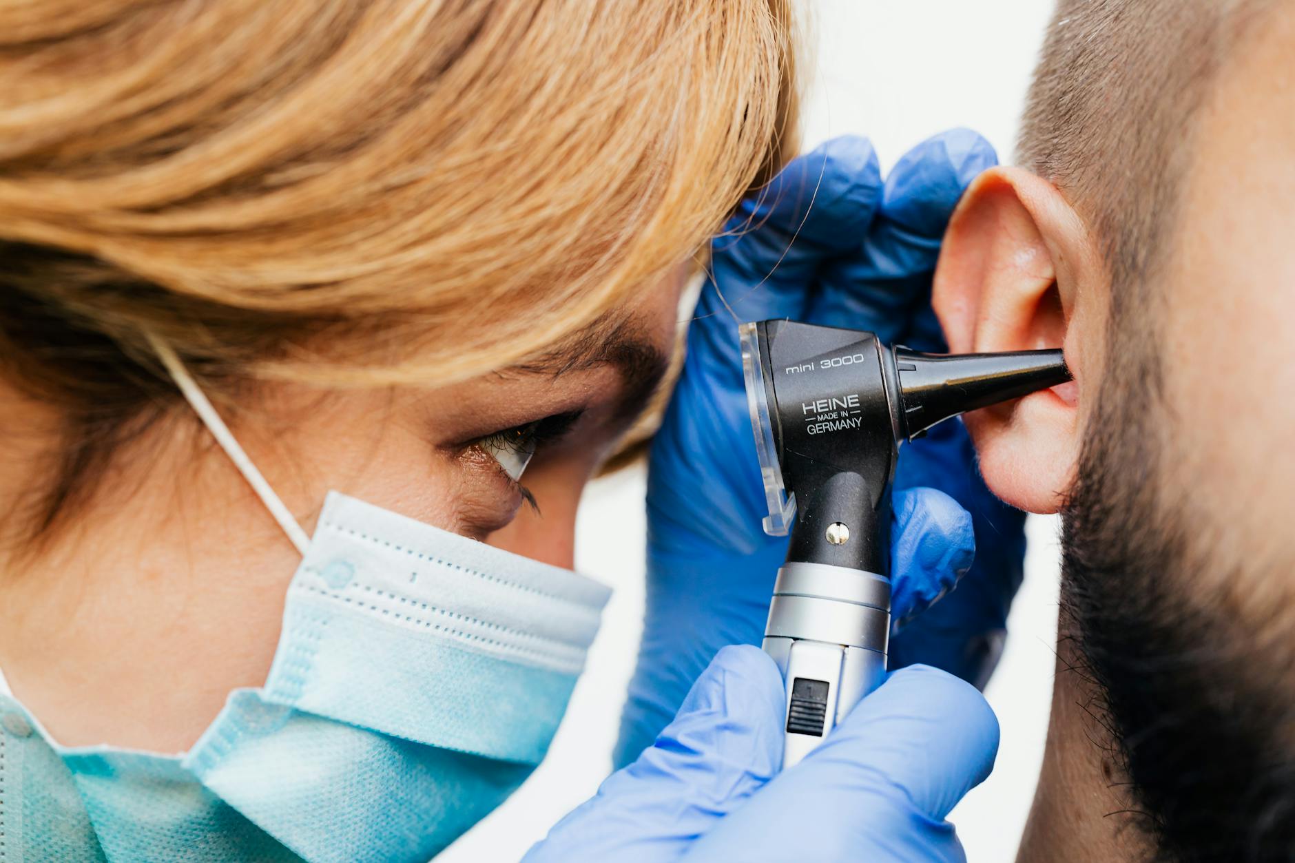 a doctor doing an ear examination Living With Tinnitus: How to Cope With Ringing in the Ears