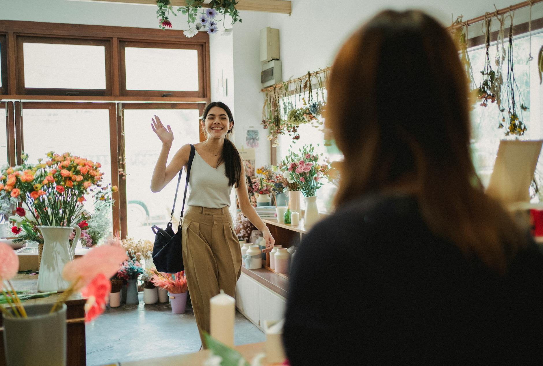 happy woman waving to florist 10 Ways to Make Clients Feel Comfortable in Your Office