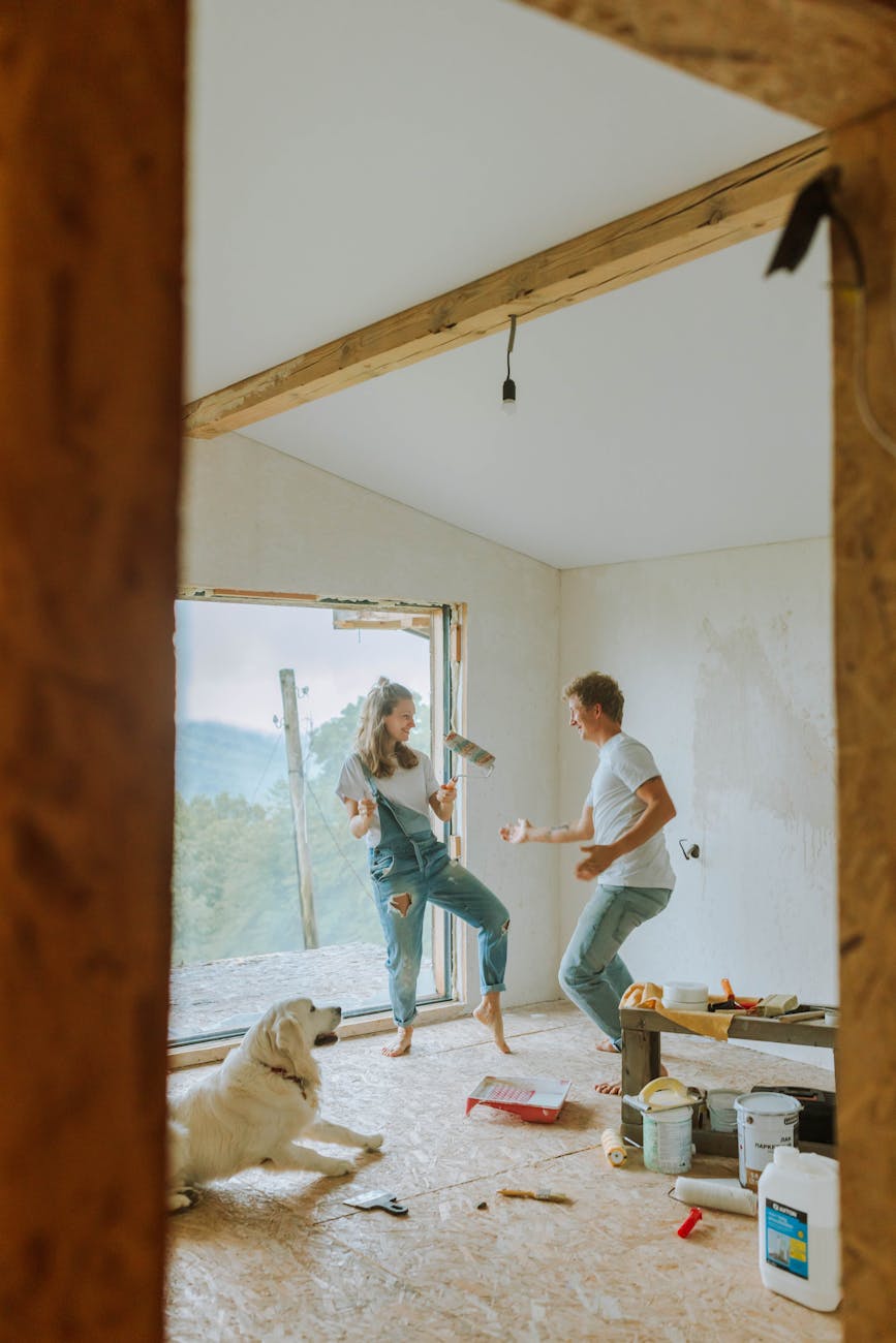8 Things You’ll Regret Not Doing Before Moving Into Your New Home 15 a couple painting a room 8 Things You’ll Regret Not Doing Before Moving Into Your New Home