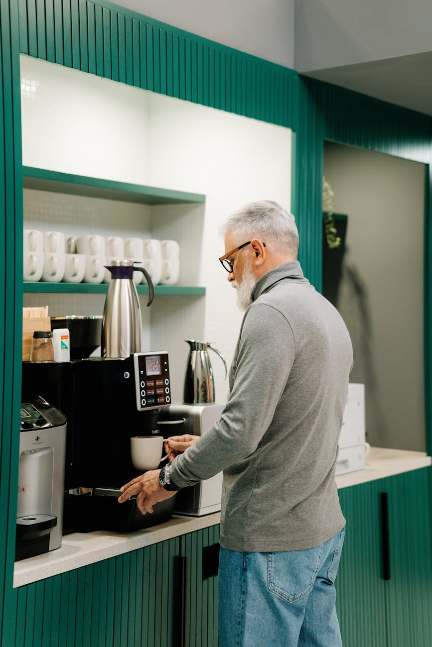 man in gray sweater standing in kitchen How to Make Clients Feel Valued Before You Even Speak