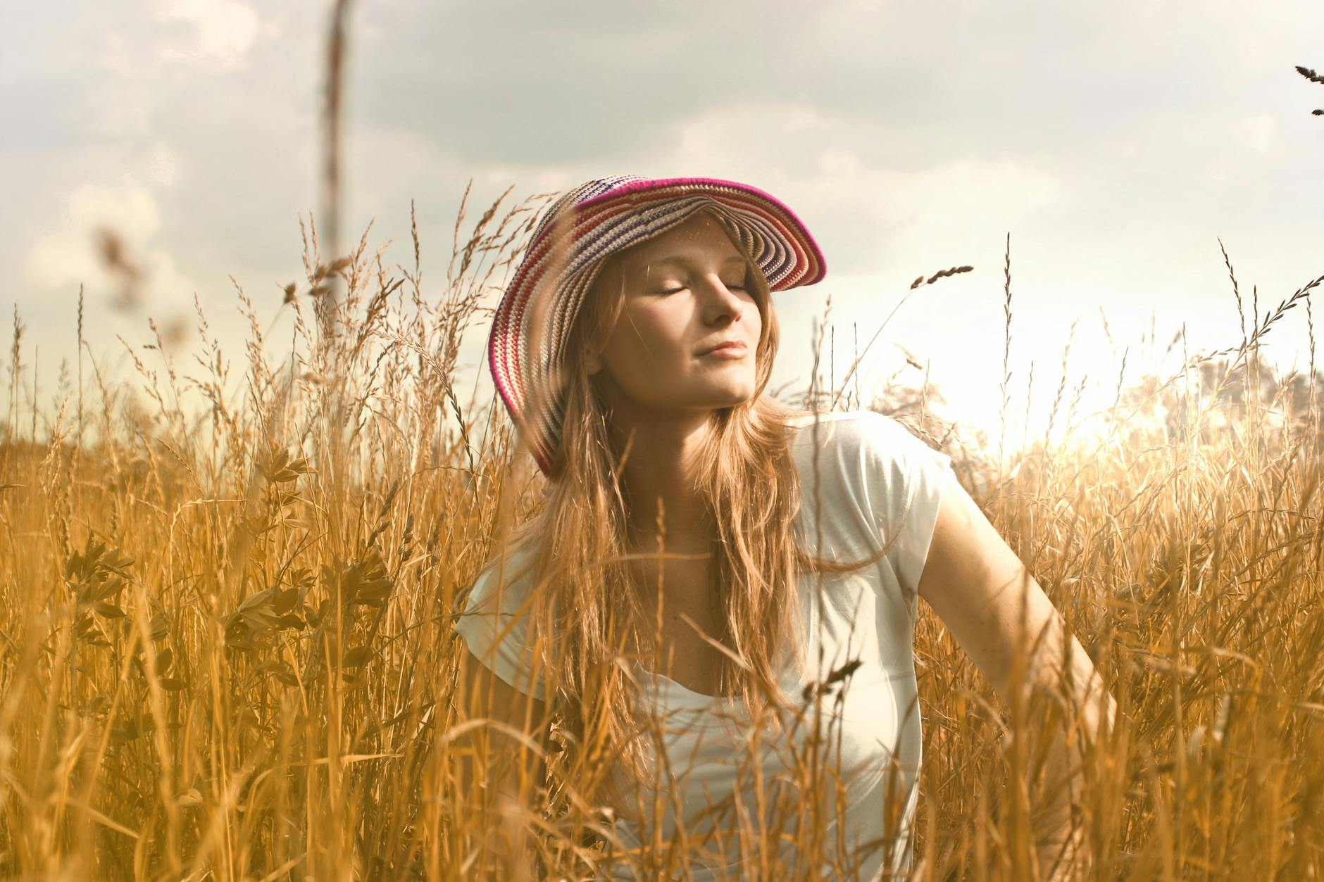 woman wearing white top and red and white sunny hat 6 Empowering Ways to Reclaim How You Feel About Yourself