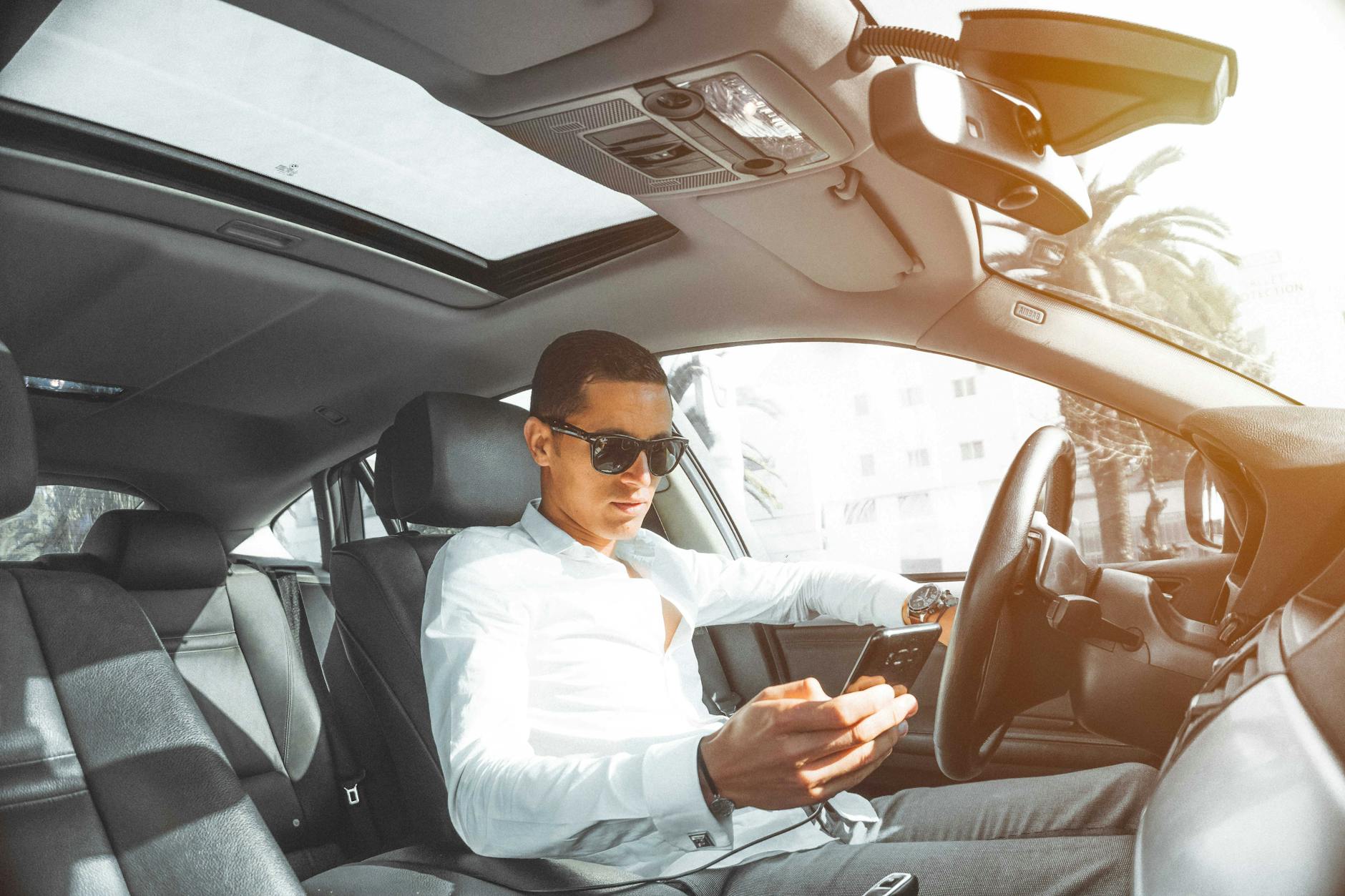 man in white dress shirt holding smartphone How to Protect Yourself After a Hit-and-Run