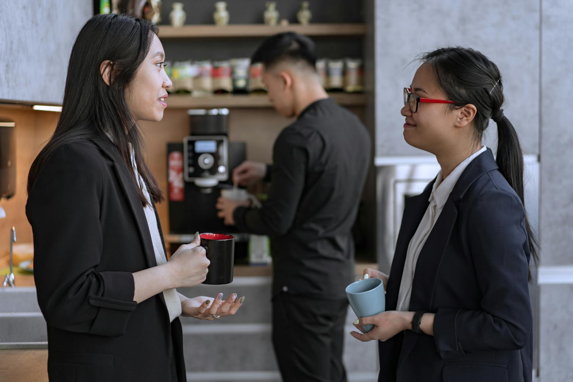 smiling women talking at break at office 10 Ways to Make Clients Feel Comfortable in Your Office