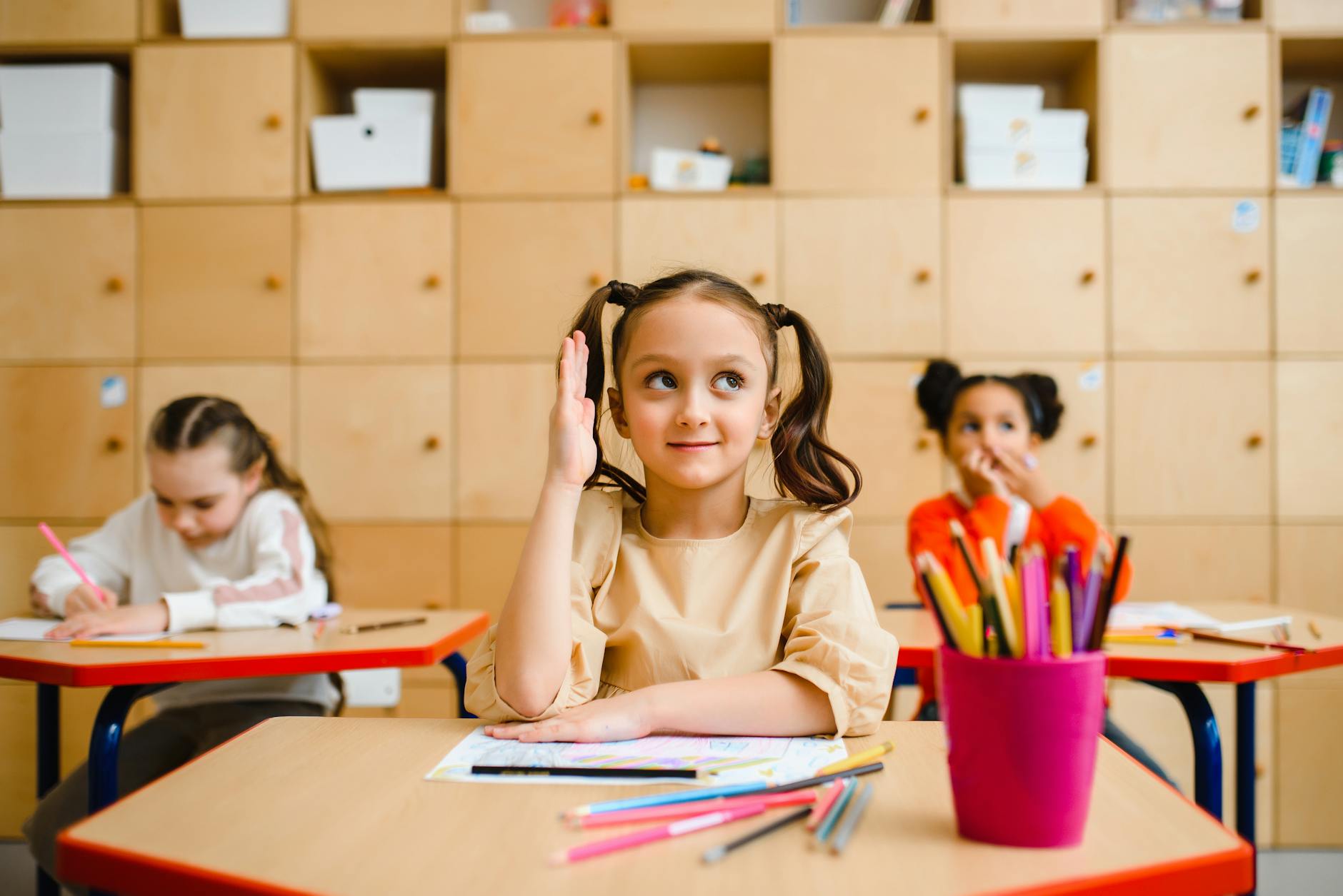 girl sitting at her desk at her school What to Do When Your Child Is Struggling to Make Friends at School