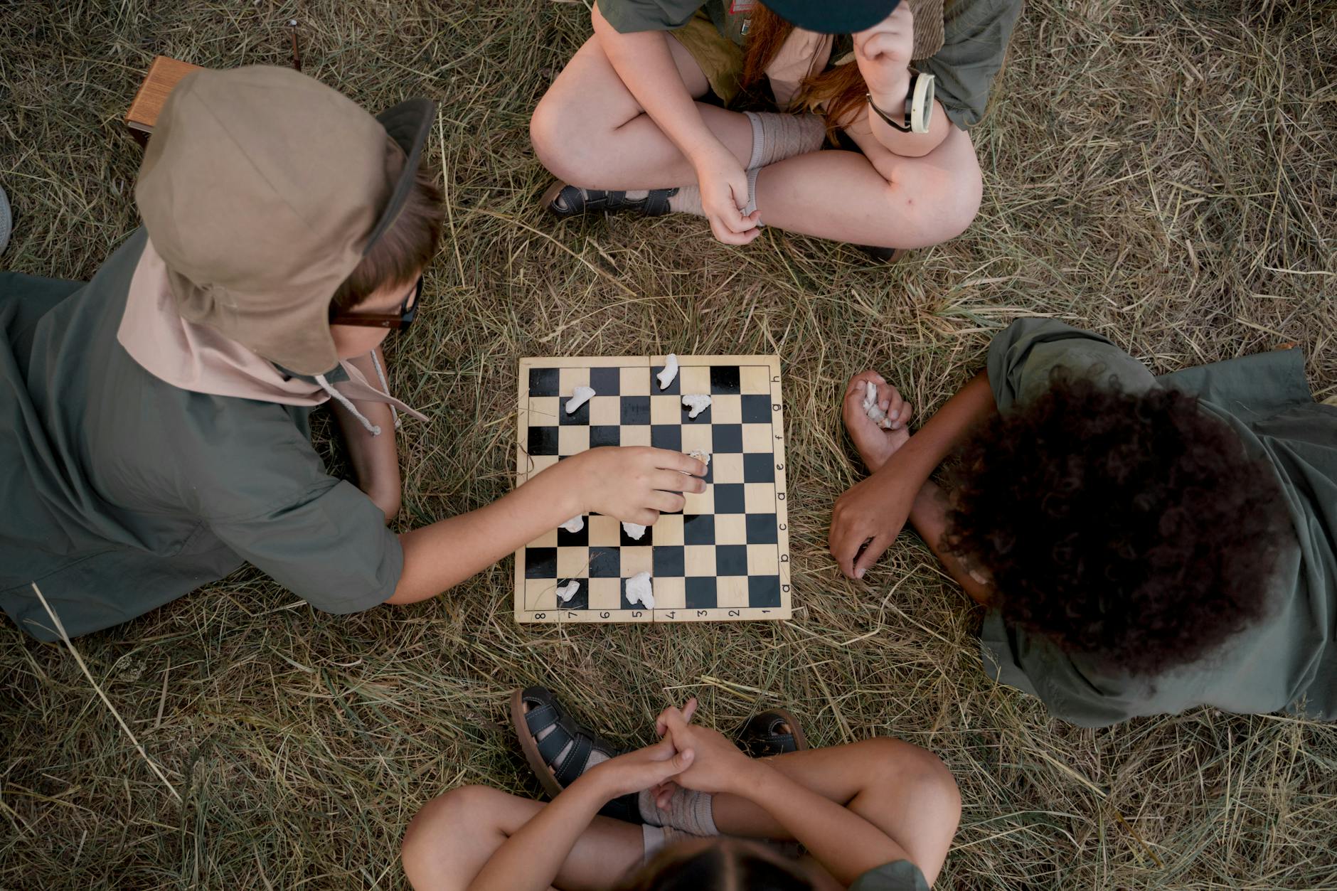 overhead shot of kids playing a board game What to Do When Your Child Is Struggling to Make Friends at School
