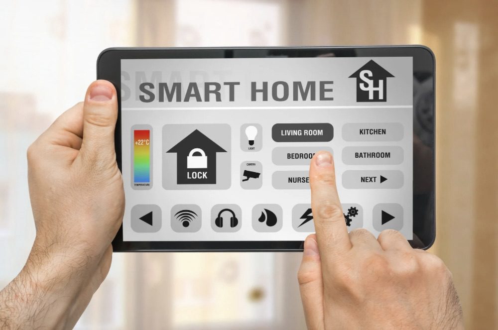 Close-up of a person holding a tablet displaying a smart home control interface, showing options for temperature, security, and room management. The Rise of Practical Smart Gear for Tactical Tech at Home