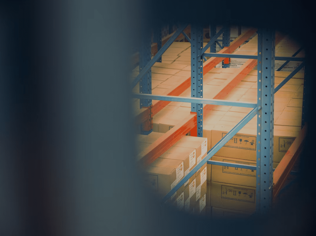 A close-up view of neatly stacked brown boxes on a gray shelf in a warehouse, emphasizing organization in supply chain management. Tips For Mastering Your Supply Chain In The Digital Age