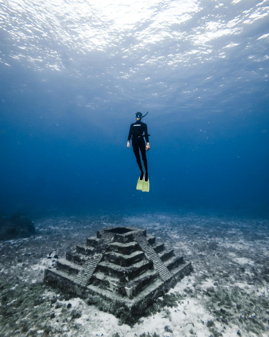 6 Careers That Let You Travel and Work At The Same Time 13 underwater shot of a diver and a built structure 6 Careers That Let You Travel and Work At The Same Time