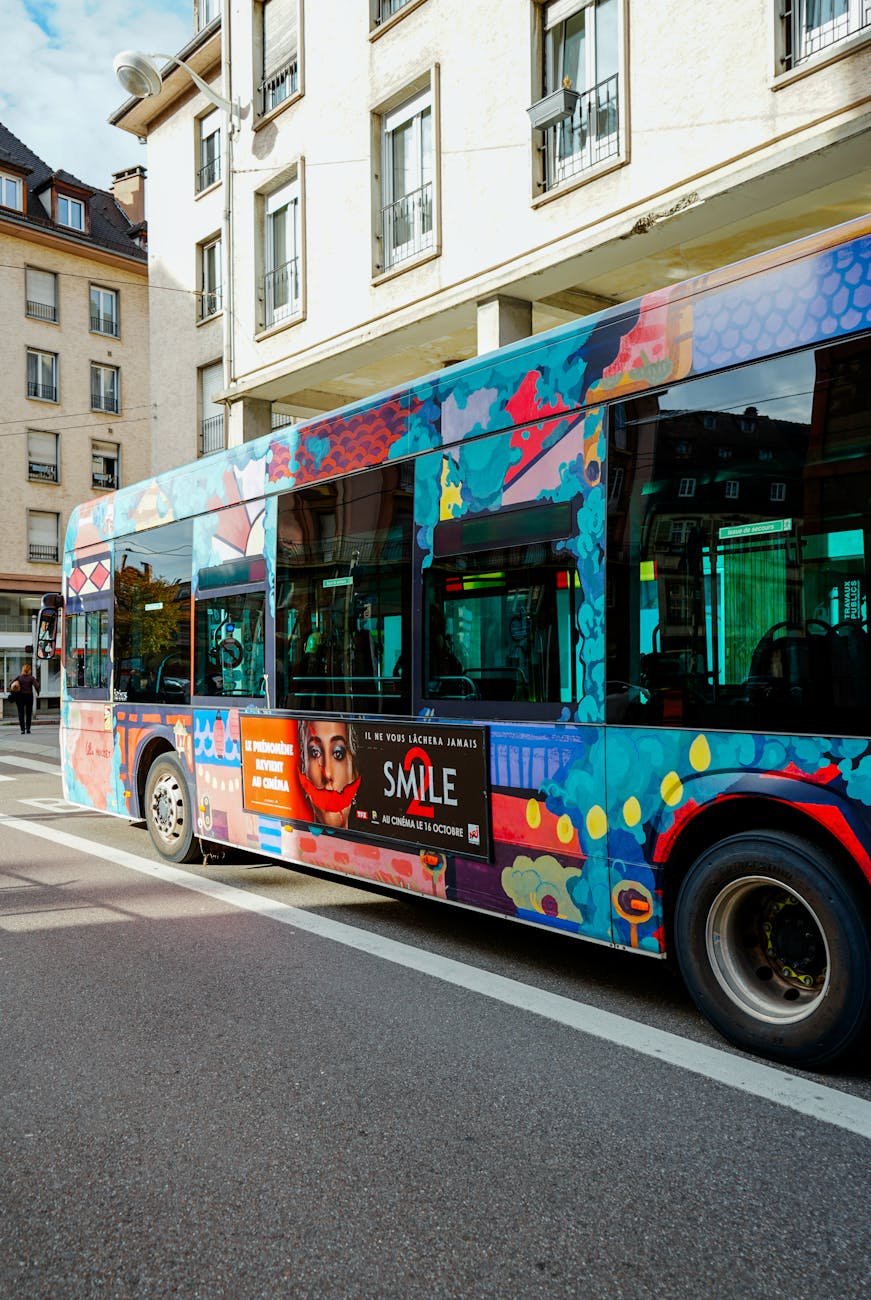 colorful bus on city street with artwork Sustainability Mindset: 7 Ethical Ways to Cut Carbon on Your Commute