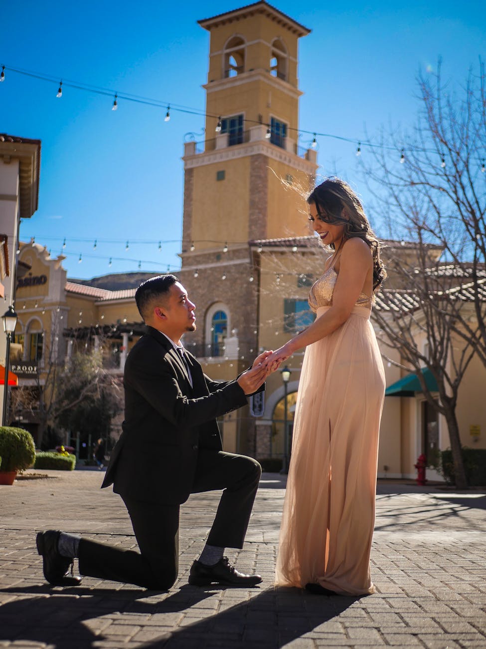 man kneel in front of woman Best Stores Where You Can Buy Gold Engagement Rings